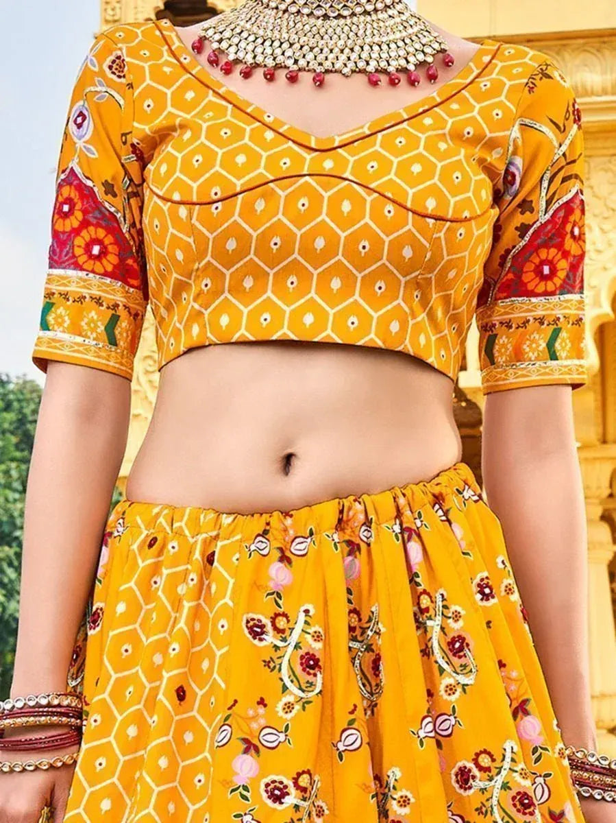 Yellow printed lehenga choli with floral sleeves and traditional jewelry, perfect for ethnic occasions