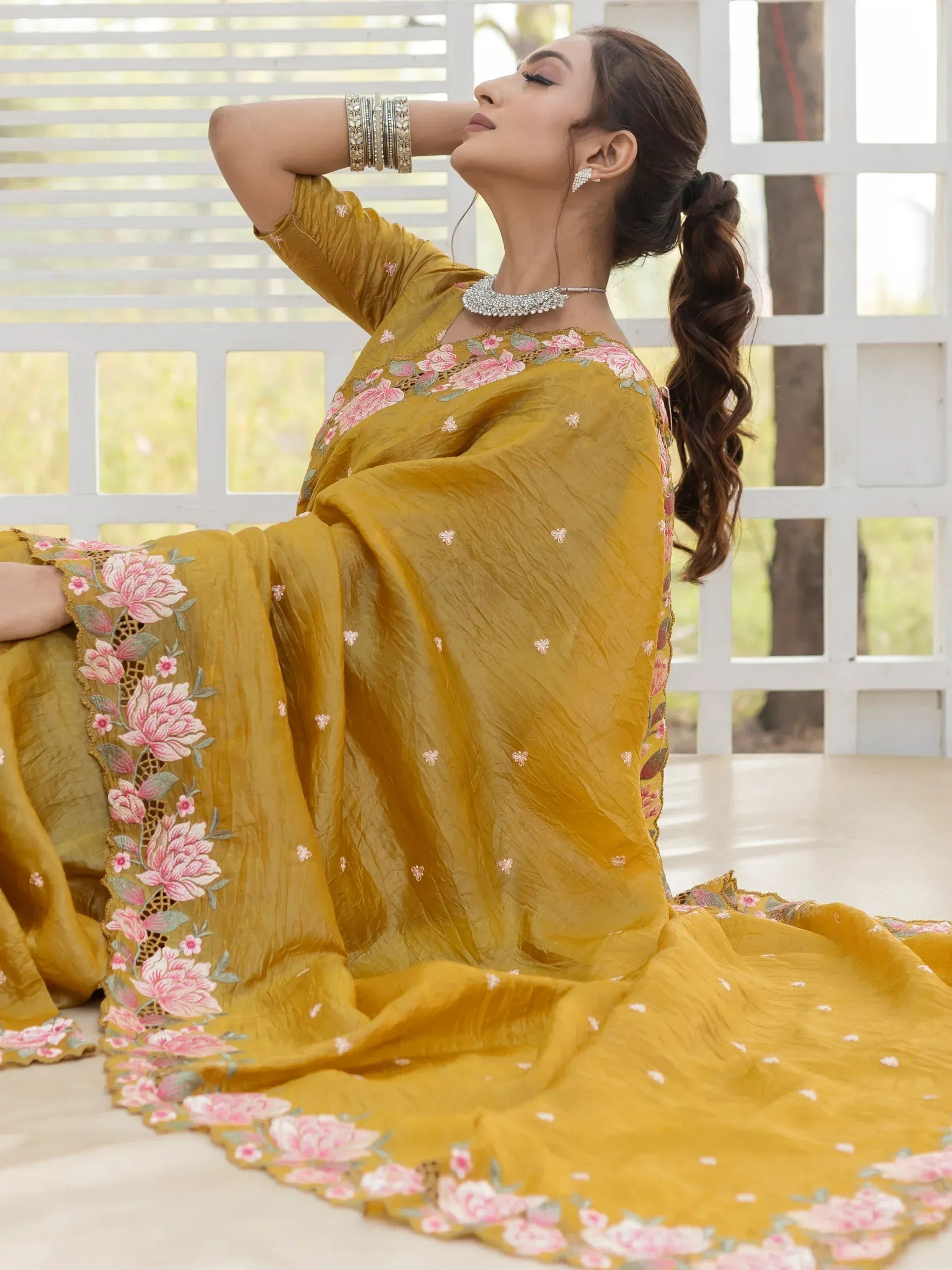 Mustard yellow ethnic gown with pink floral embroidery, perfect for Indian occasions