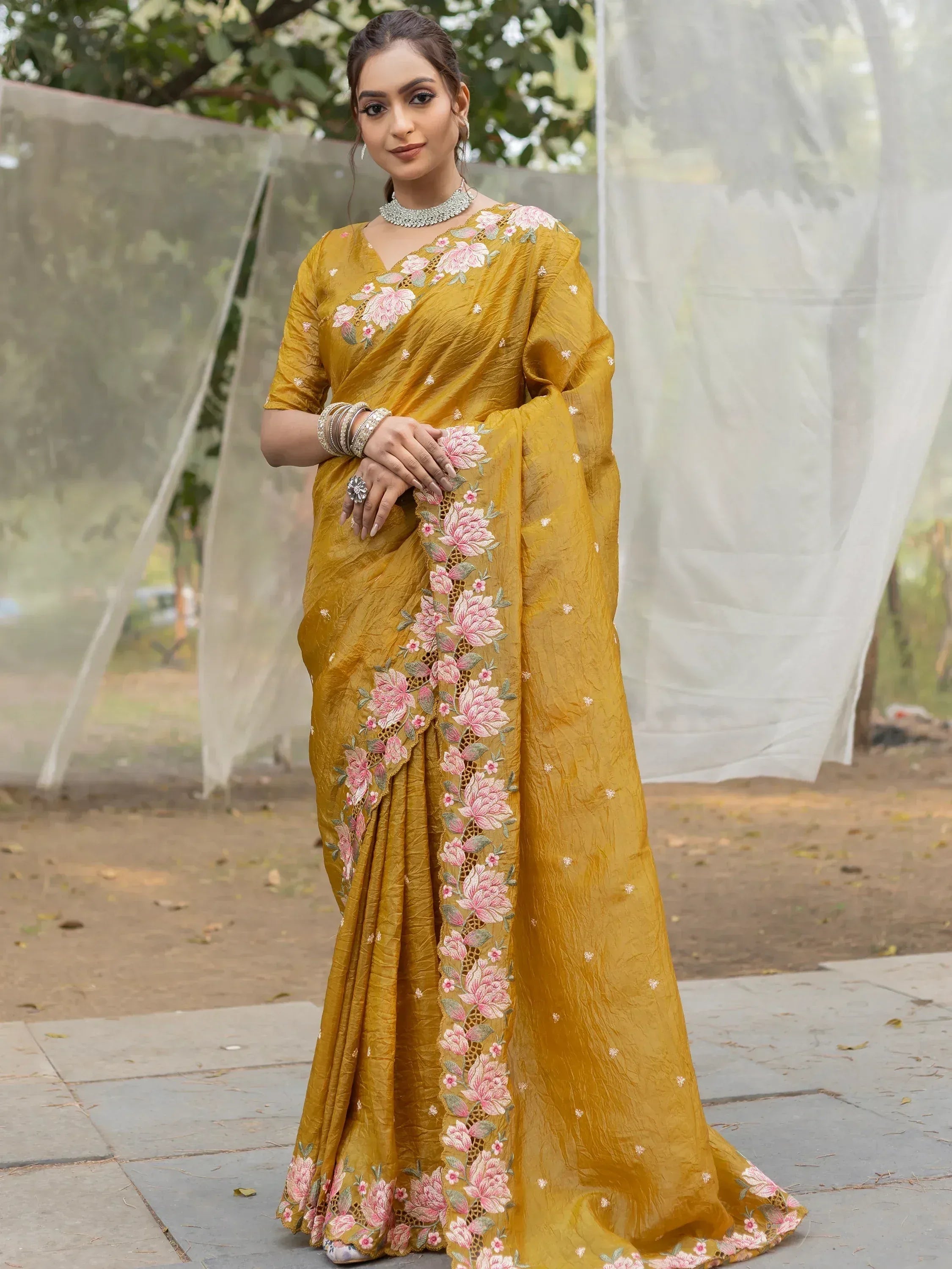 Mustard yellow saree with pink floral embroidery, perfect for ethnic occasions and Indian weddings.