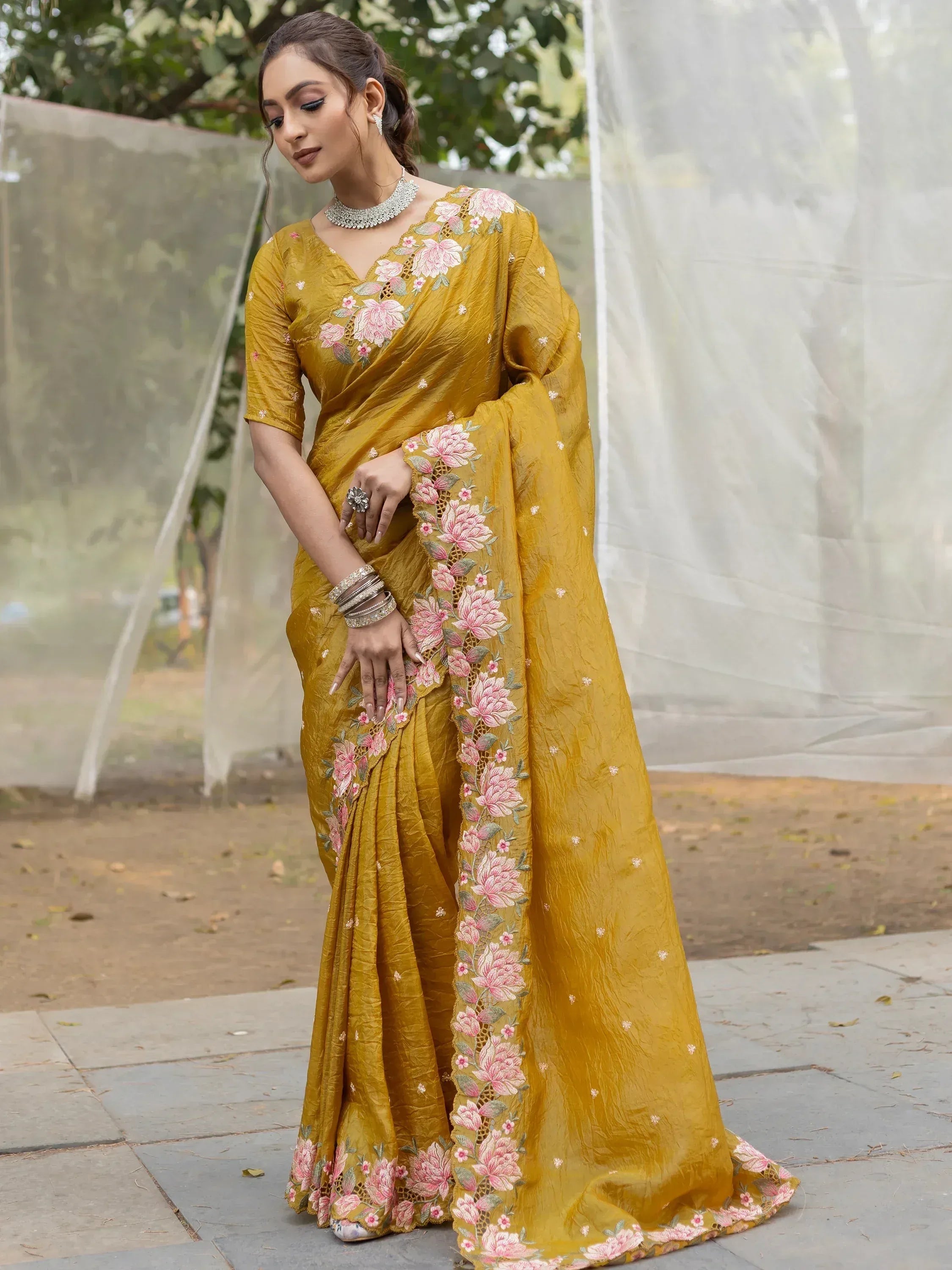Mustard yellow saree with pink floral embroidery, perfect for Indian ethnic wear occasions