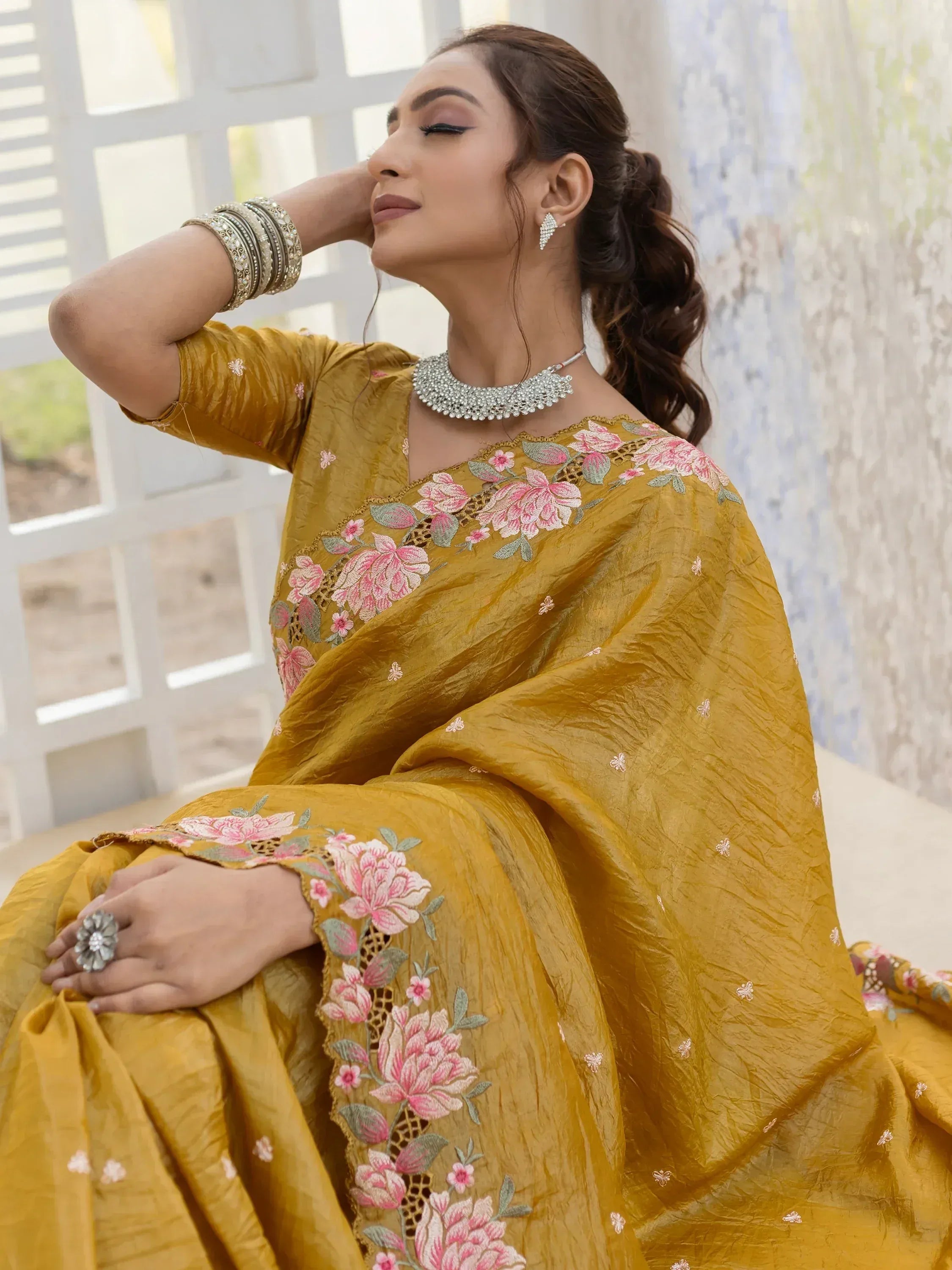 Mustard yellow embroidered saree with pink floral design, perfect for Indian ethnic wear occasions