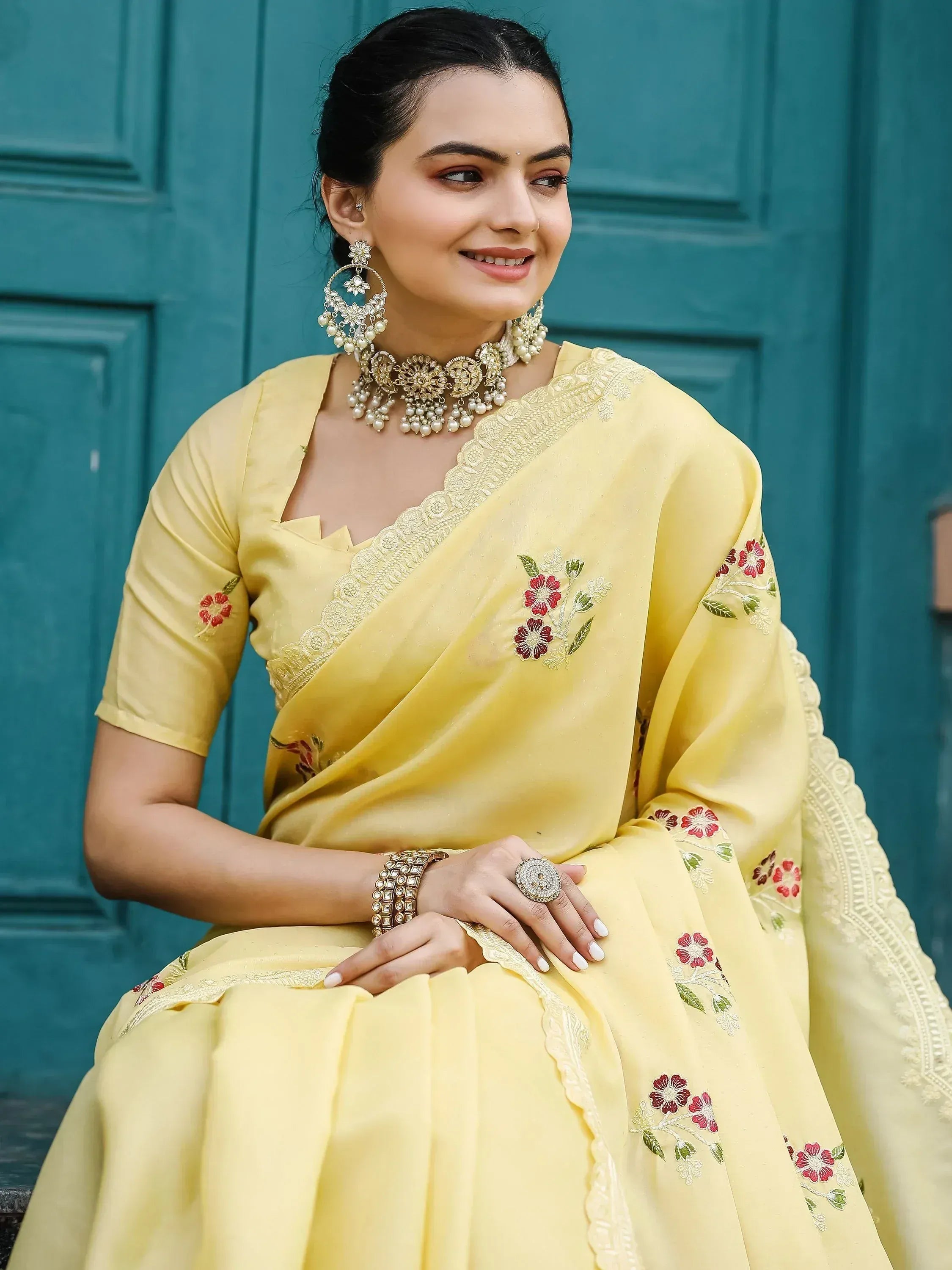 Yellow floral embroidered saree with gold jewelry, perfect for Indian ethnic wear occasions