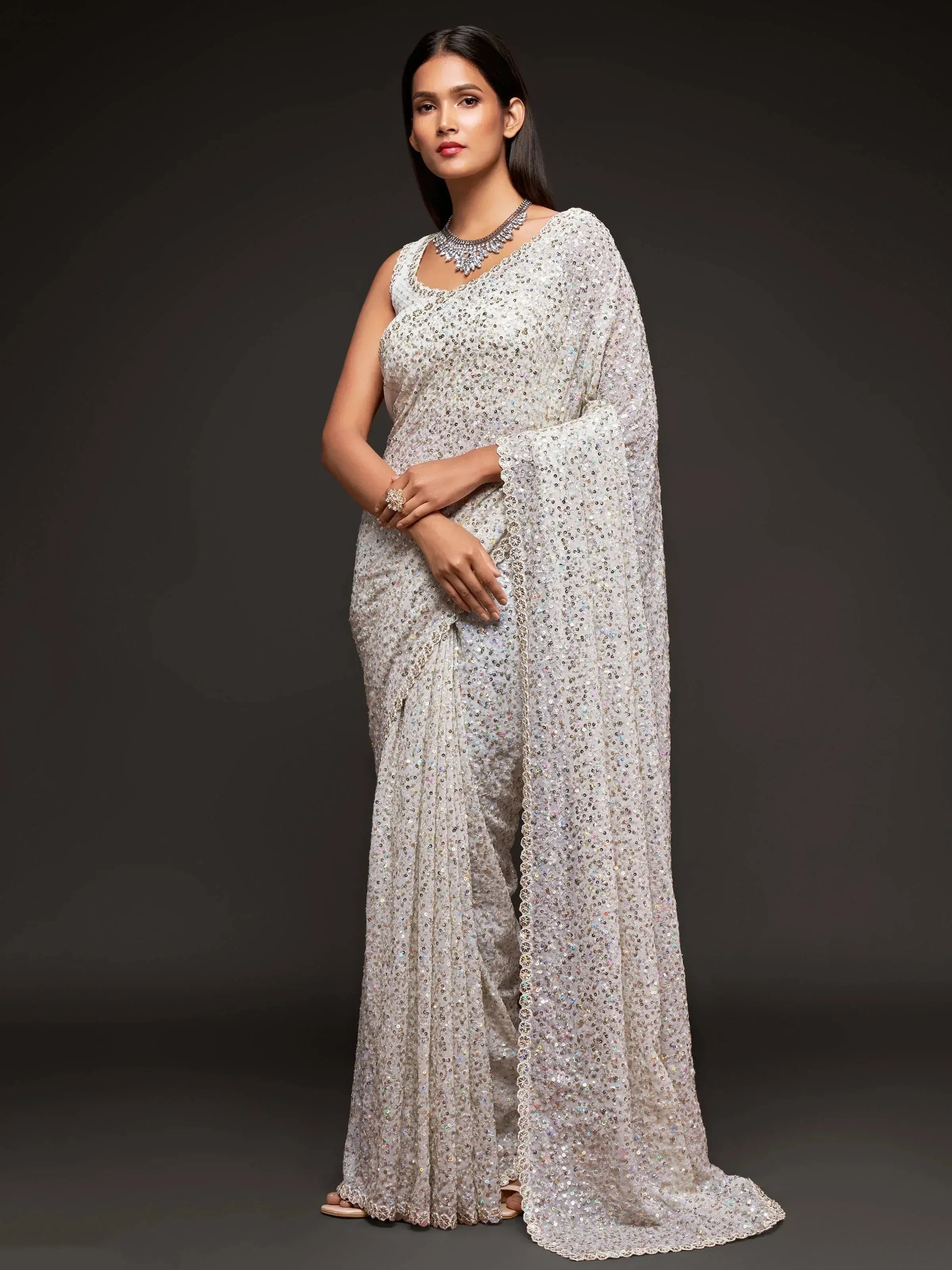 Elegant white sequin saree with cape sleeve, perfect for Indian ethnic occasions and festive wear.