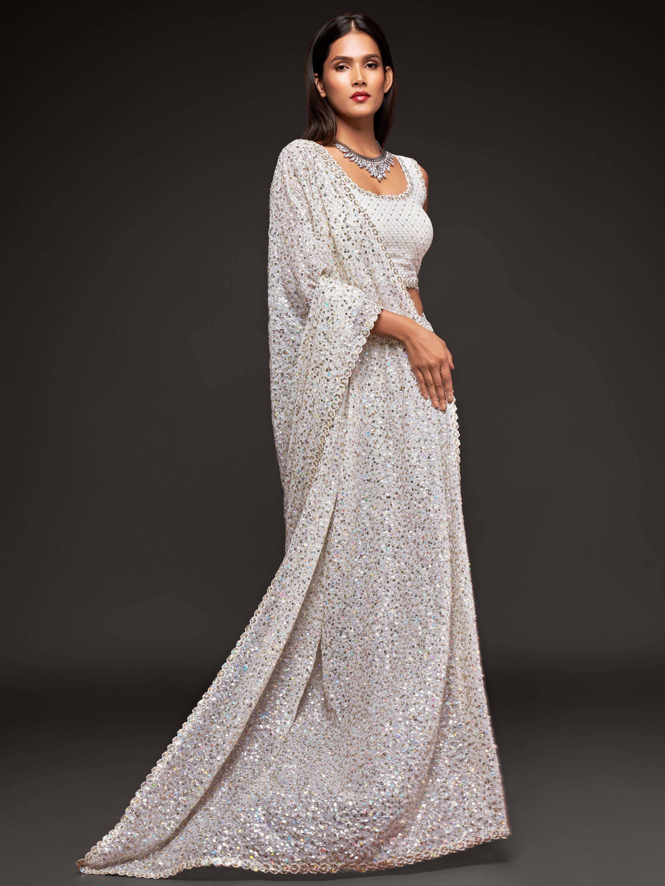 Elegant white sequined lehenga choli with cape, perfect for Indian weddings and festive occasions.