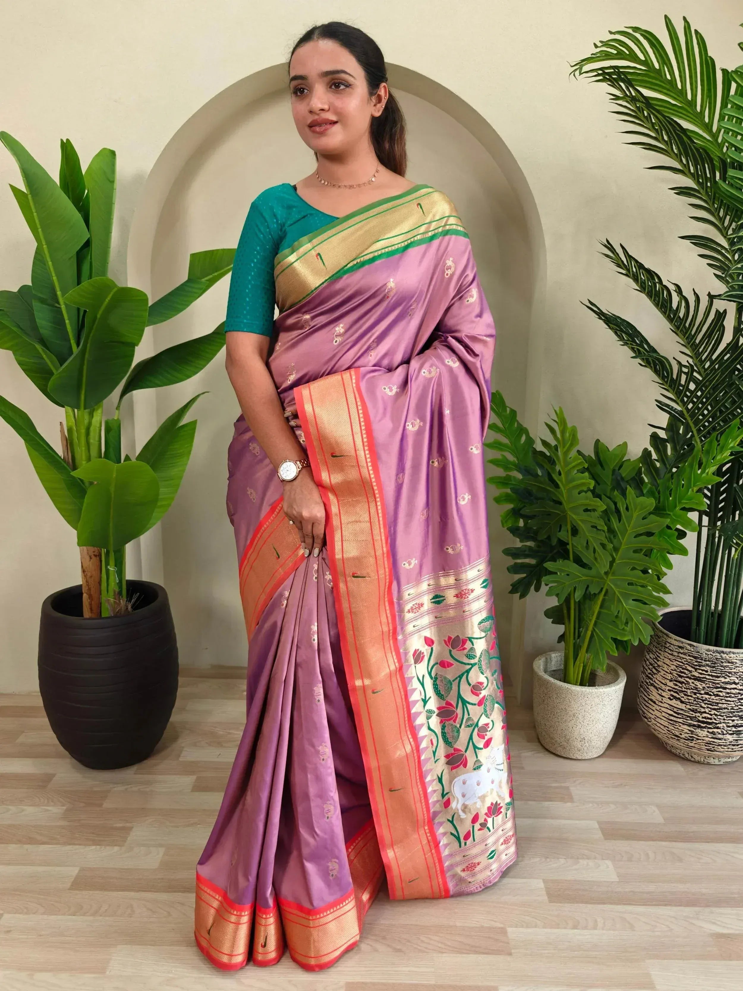 Purple silk saree with gold border and floral motifs, paired with teal blouse, ideal for Indian ethnic wear