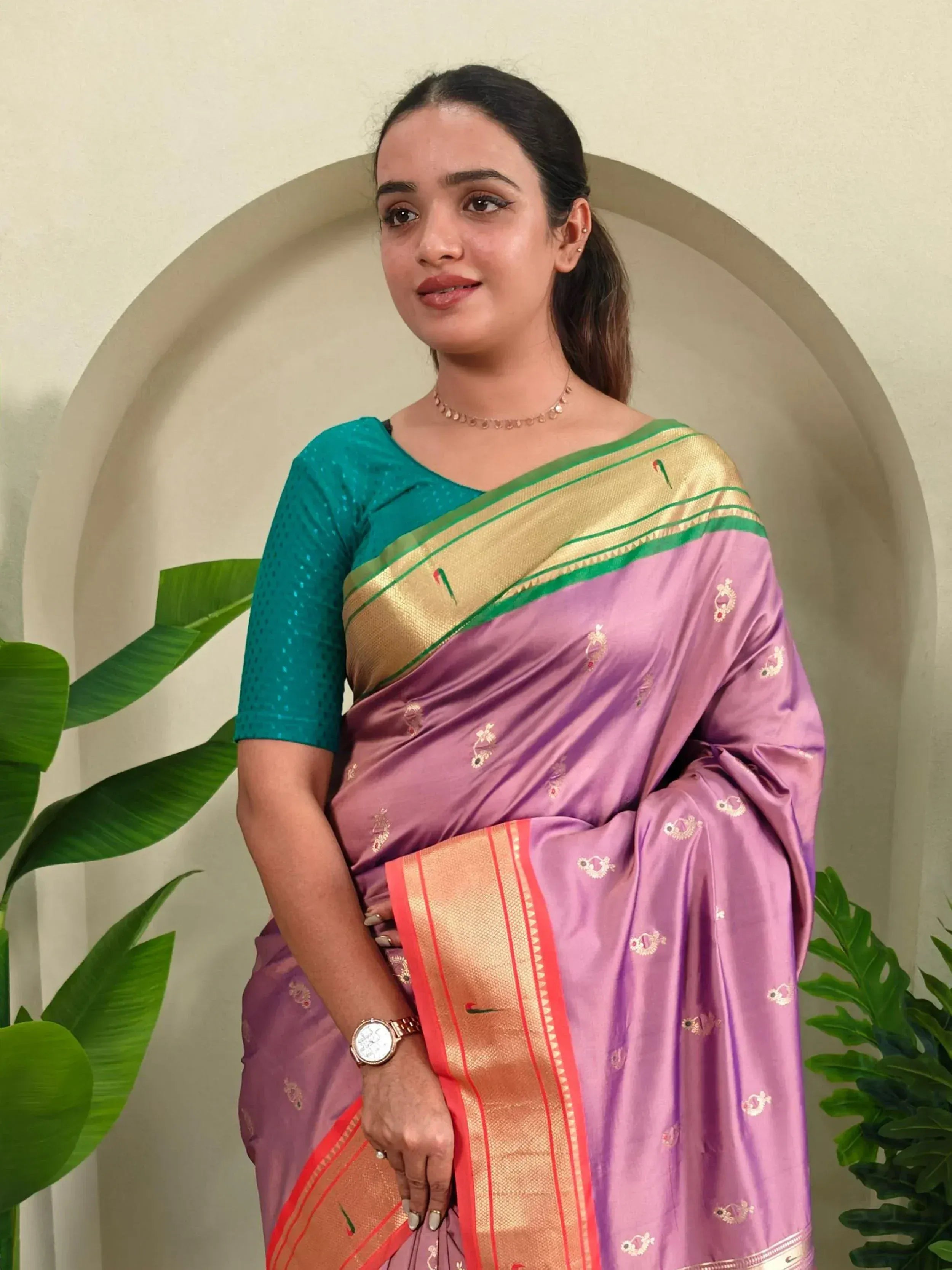 Woman in purple silk saree with gold border and teal blouse, Indian ethnic wear