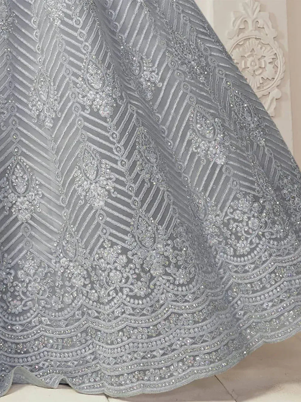 Elegant silver ethnic gown with intricate beadwork and geometric embroidery design