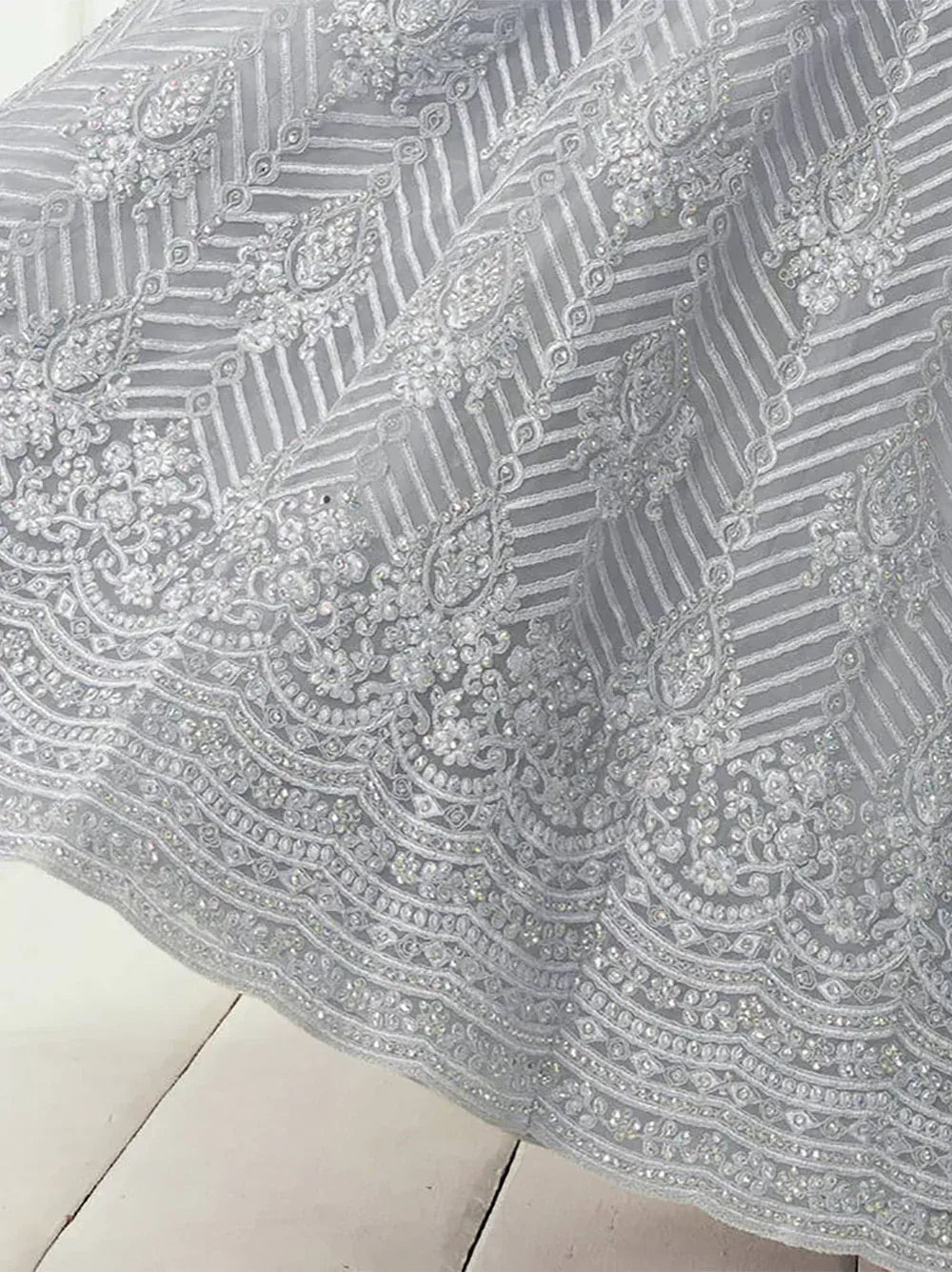 Elegant silver lehenga with intricate beadwork and floral embroidery, perfect for Indian ethnic wear