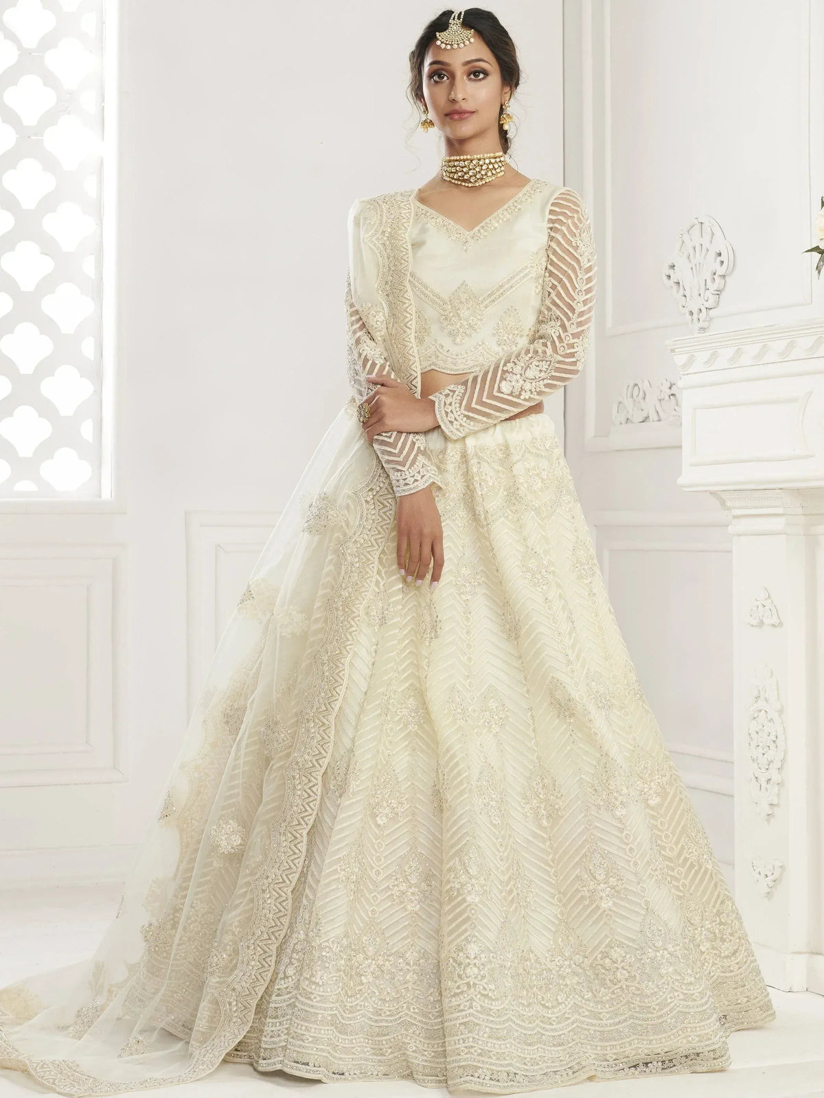 Elegant cream lehenga choli with intricate embroidery and sheer sleeves for Indian ethnic wear