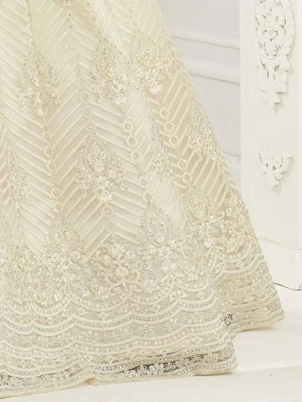 Ivory embroidered lehenga with intricate beadwork and chevron patterns, perfect for Indian ethnic wear.