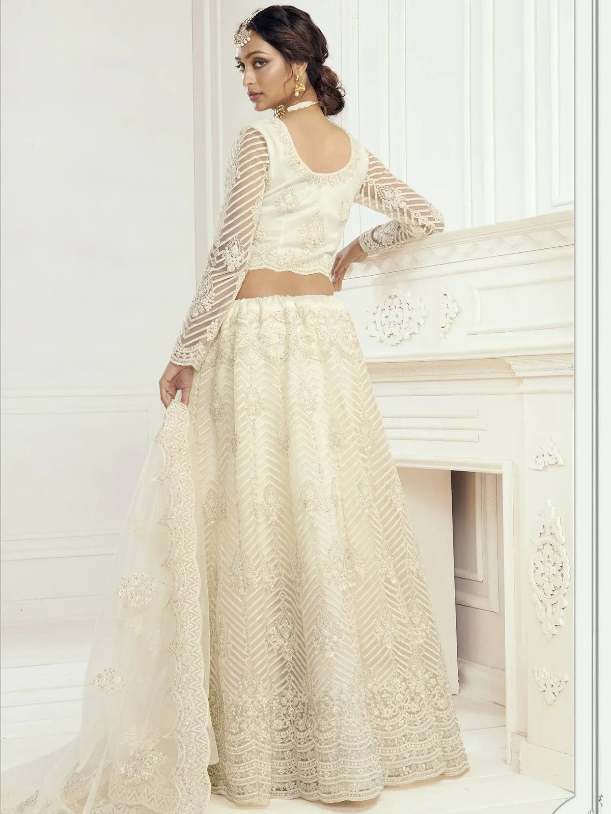 Elegant ivory lehenga choli with intricate embroidery and sheer sleeves for Indian ethnic wear