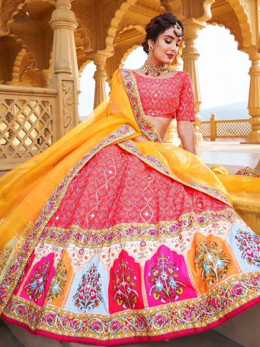 Vibrant pink and yellow designer lehenga choli with floral embroidery, perfect for Indian ethnic wear occasions.