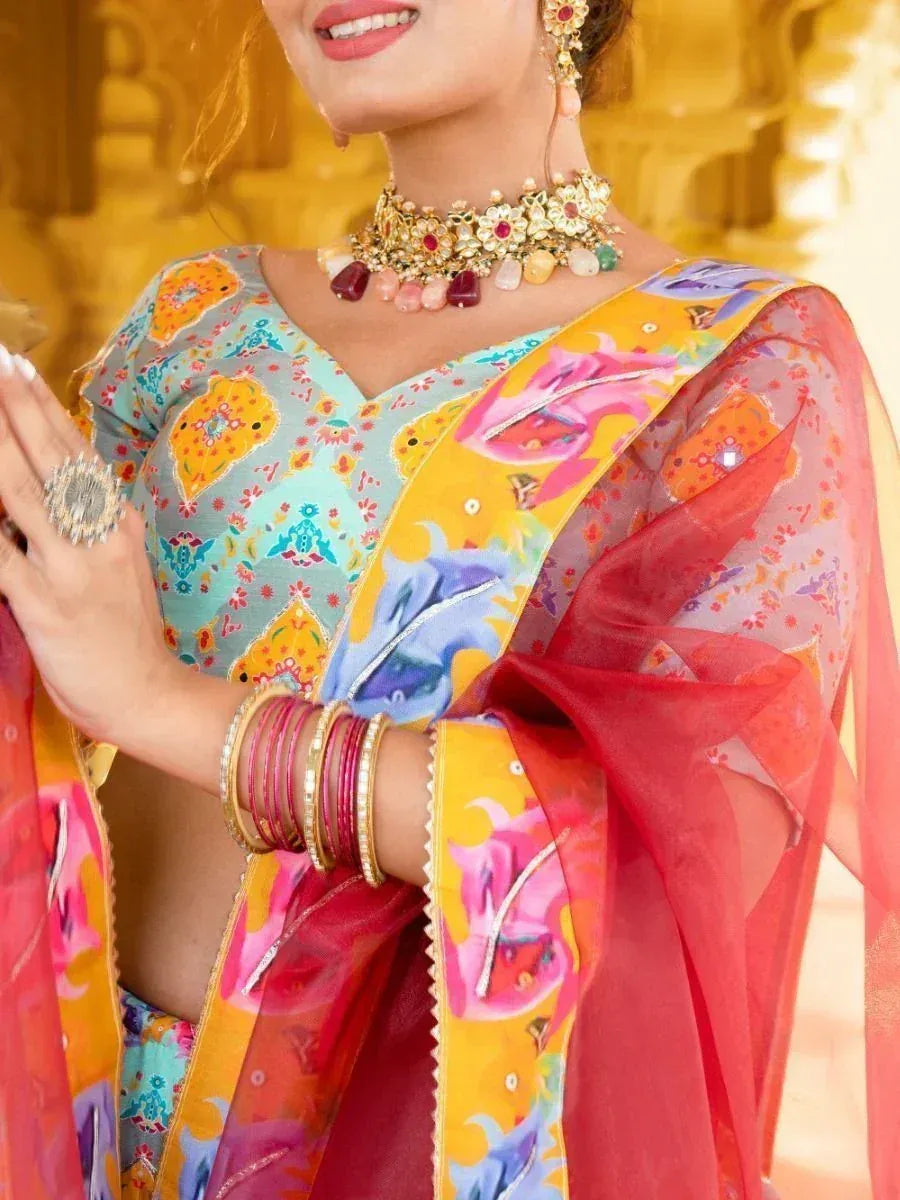 Colorful printed saree with floral motifs, gold jewelry, and bangles for Indian ethnic wear