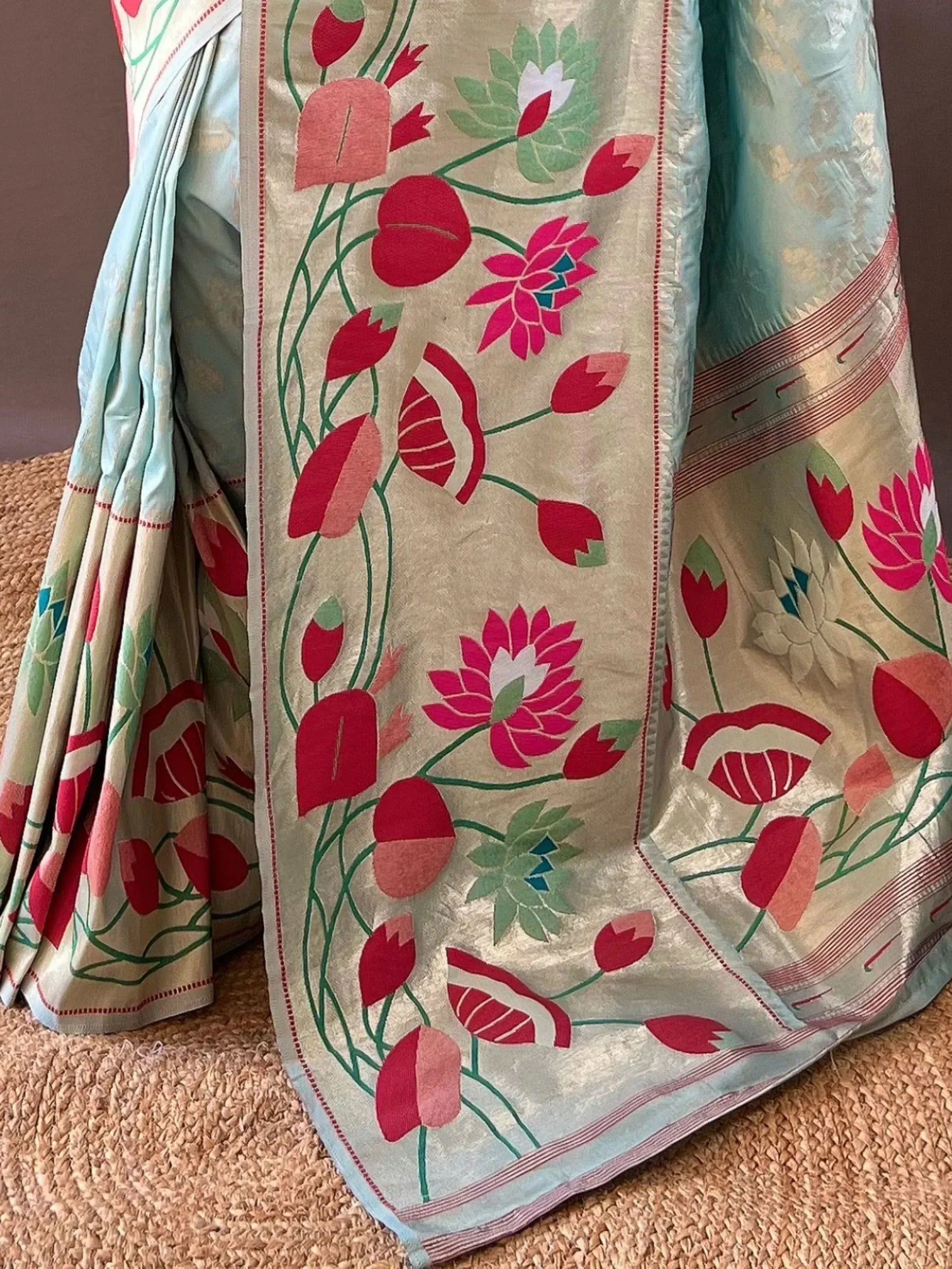 Floral printed saree with pink lotus and red buds on cream base, perfect for ethnic wear occasions