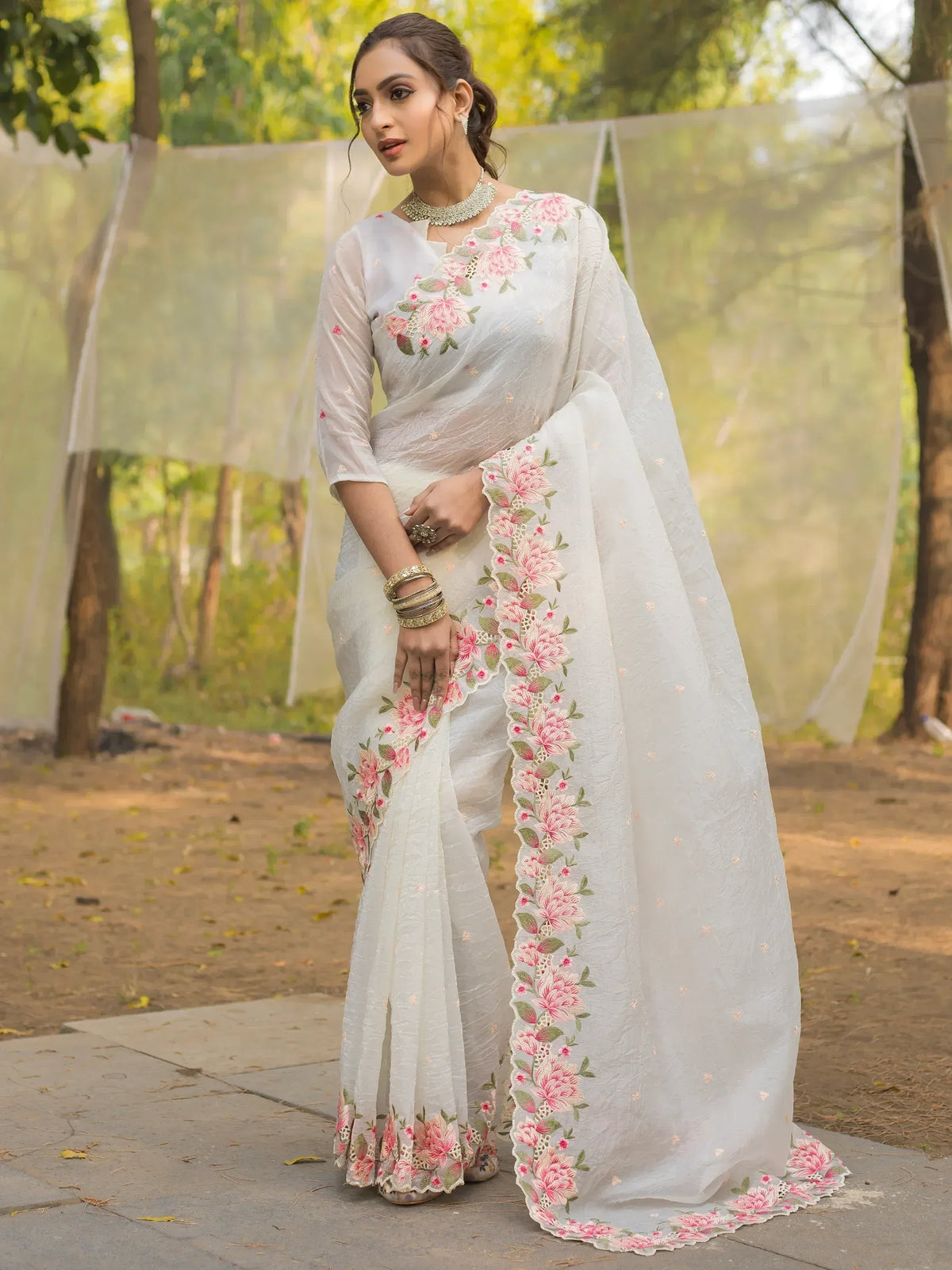 White floral embroidered saree with pink flowers, perfect for Indian ethnic wear and special occasions.