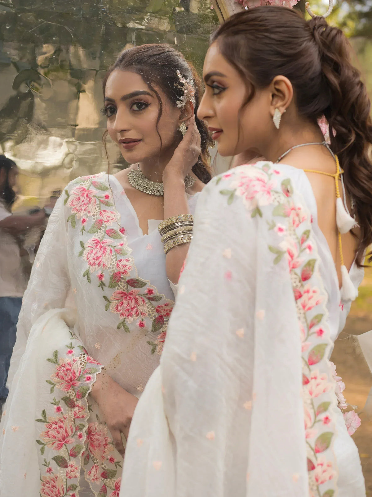 Woman in white floral embroidered ethnic gown with mirror reflection, perfect for Indian occasions