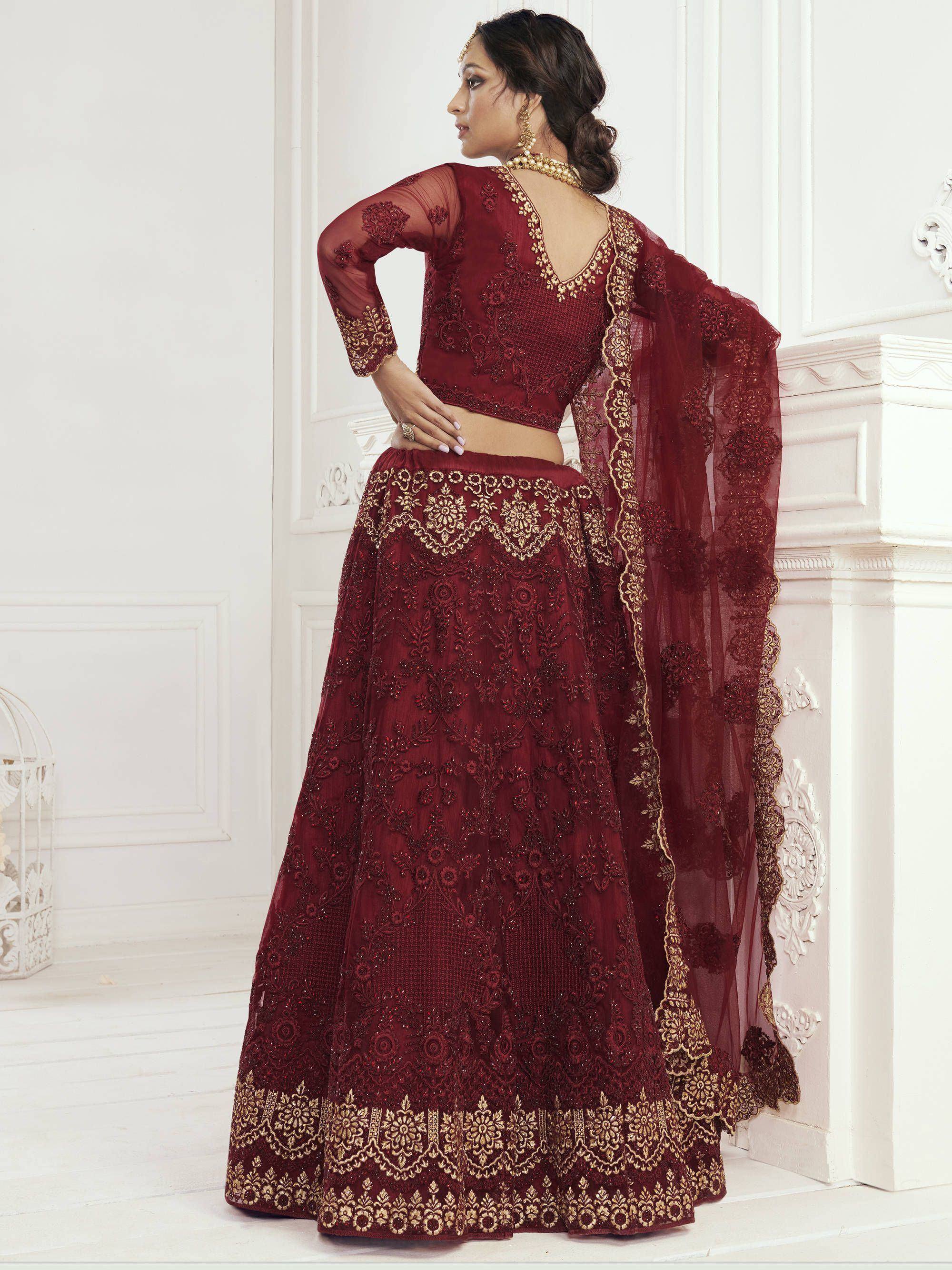 Maroon embroidered lehenga choli with gold detailing, perfect for Indian weddings and festive occasions.