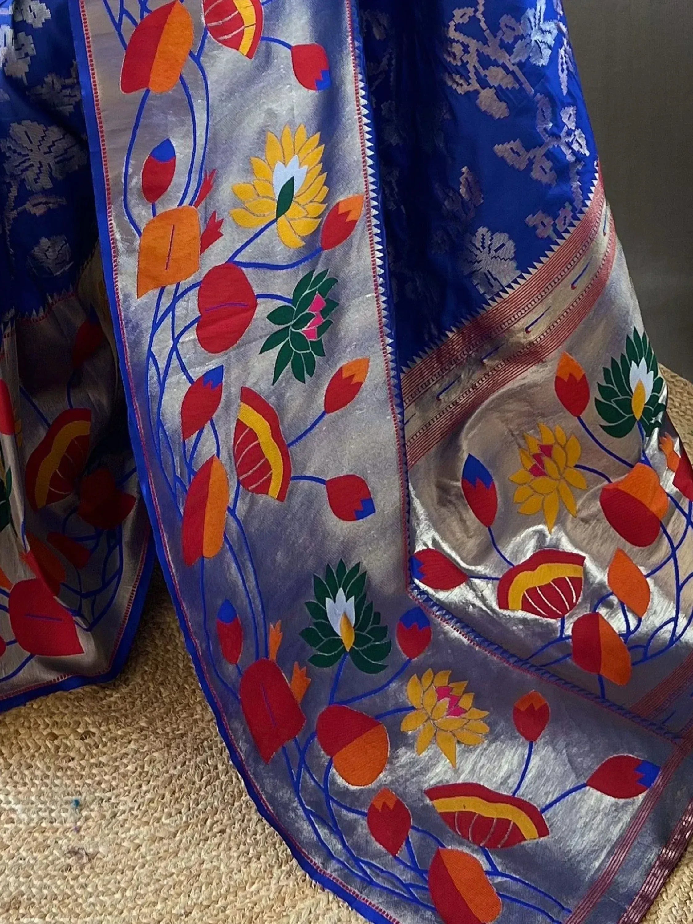 Blue and silver saree with vibrant floral embroidery, perfect for ethnic wear occasions.