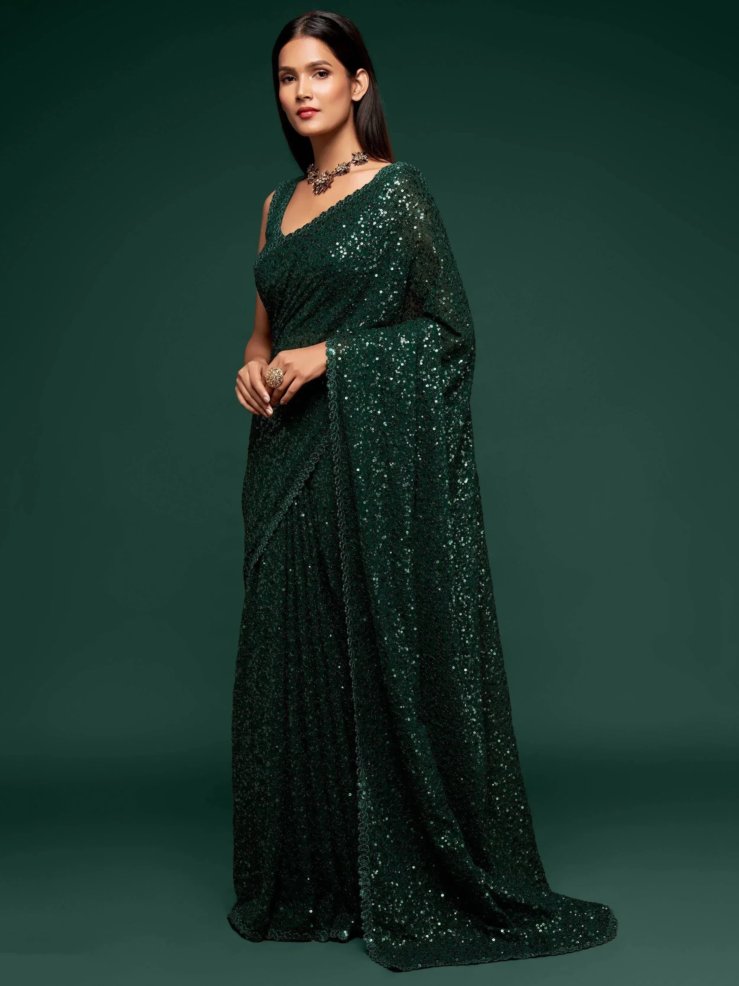 Emerald green sequin saree with V-neck blouse, perfect for Indian ethnic events and festive occasions.