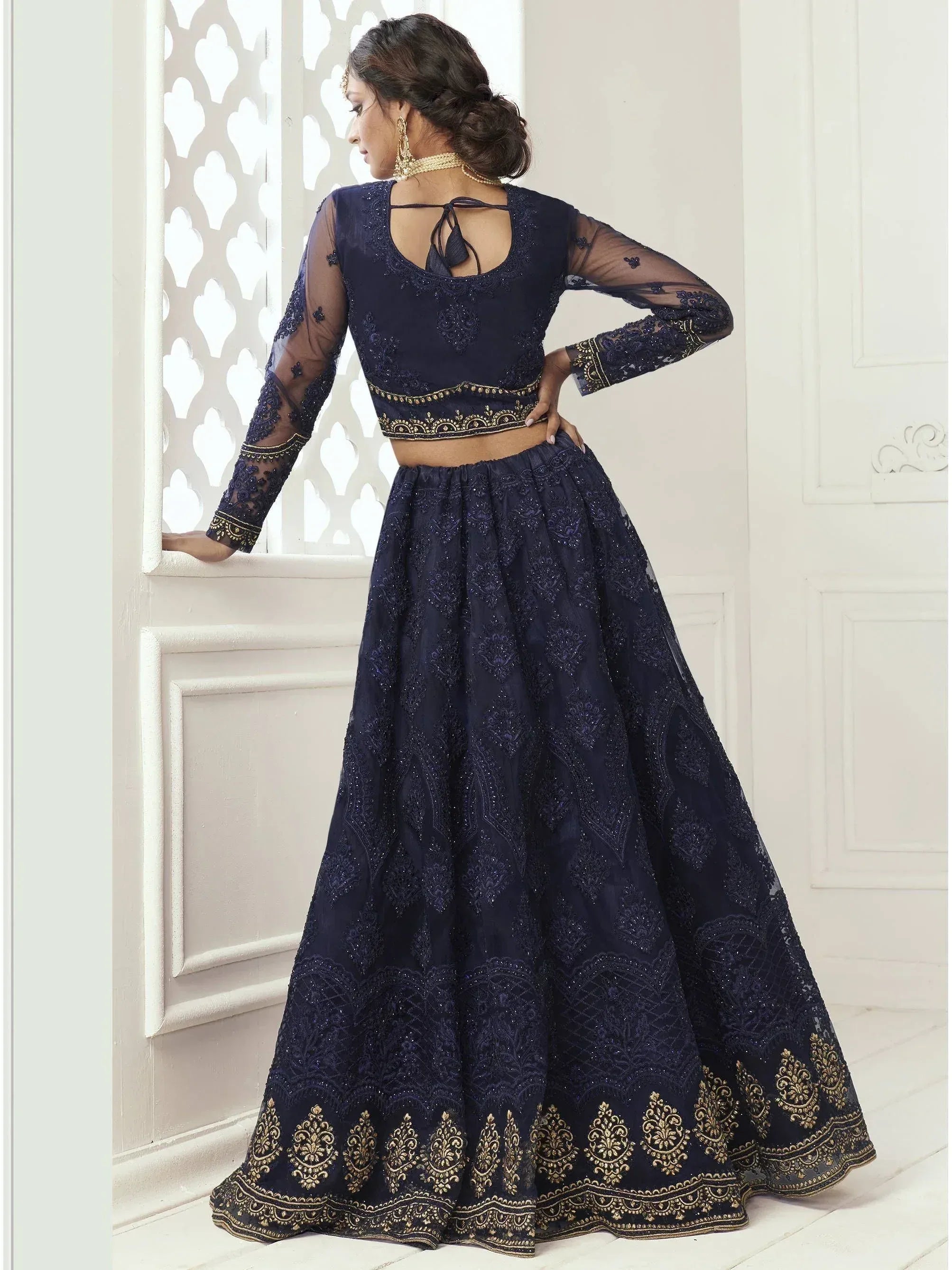 Navy blue embroidered lehenga choli with sheer sleeves and gold detailing, perfect for Indian ethnic wear