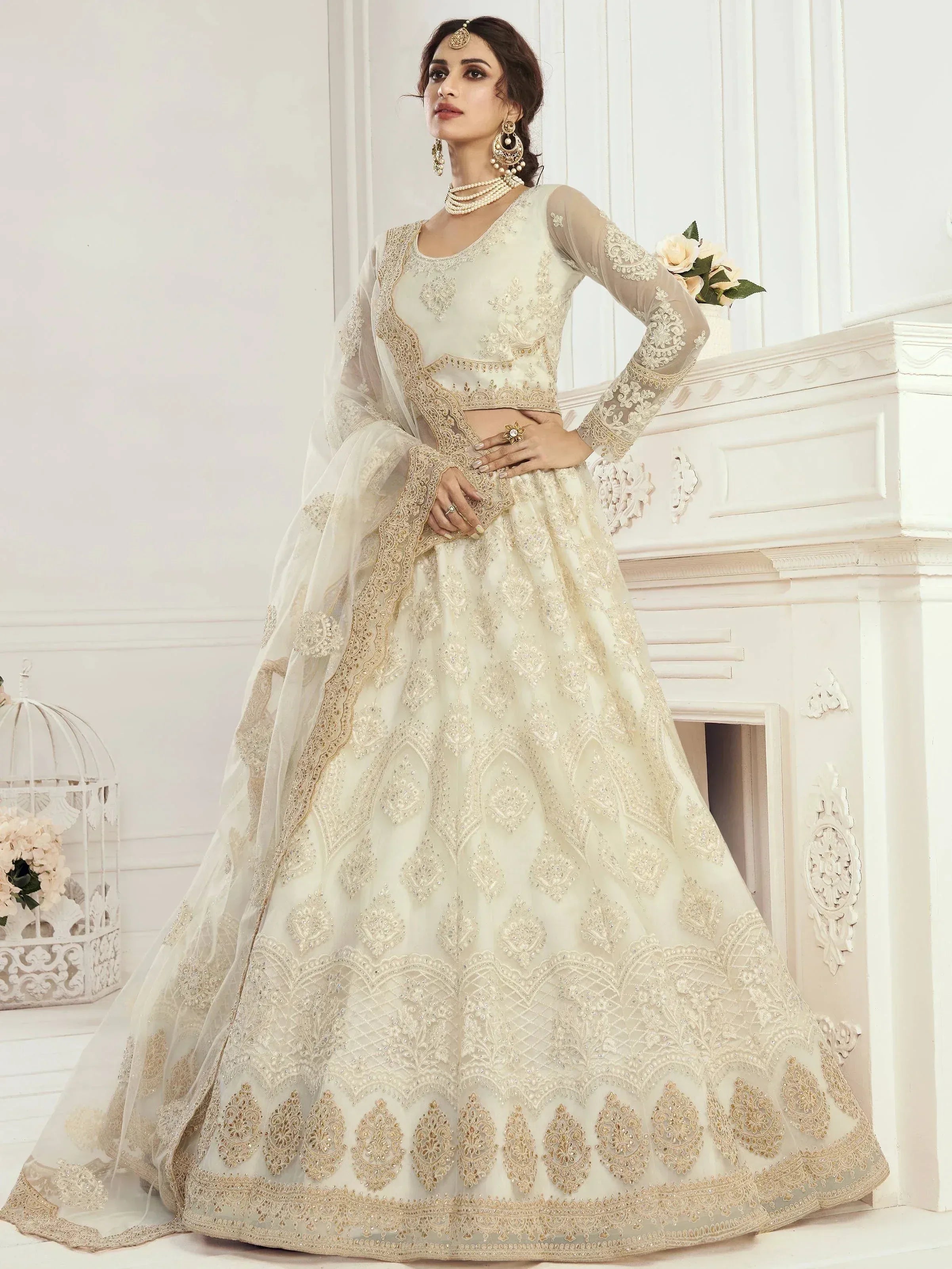 Ivory designer lehenga choli with gold embroidery, perfect for weddings and ethnic events