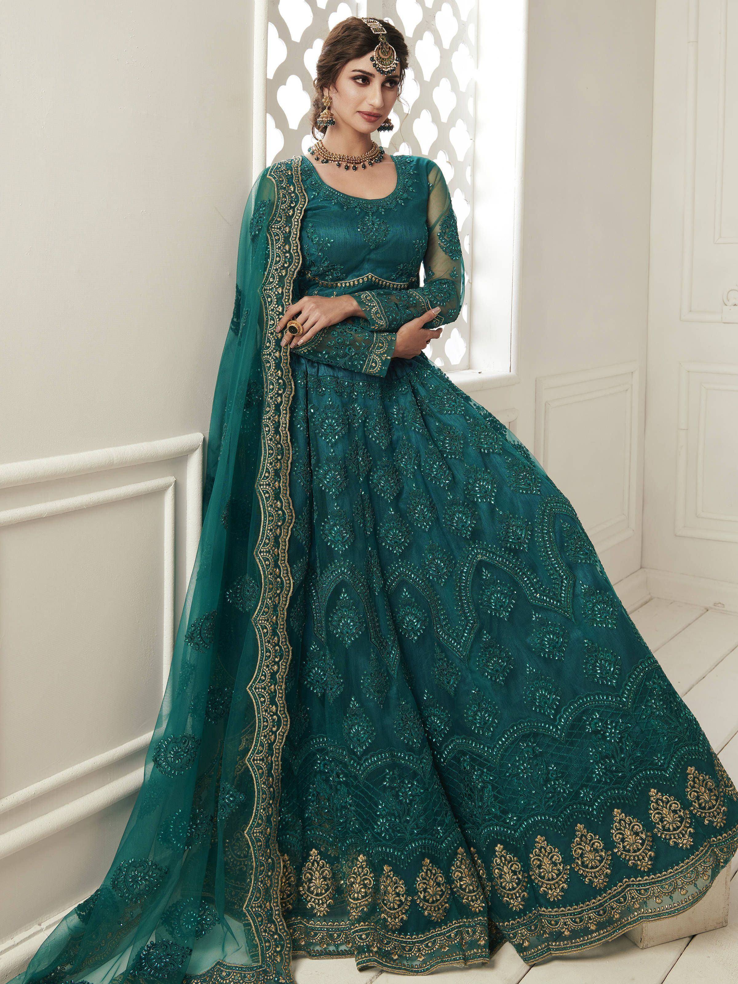 Emerald green embroidered lehenga choli with gold detailing, perfect for Indian weddings and festive occasions.