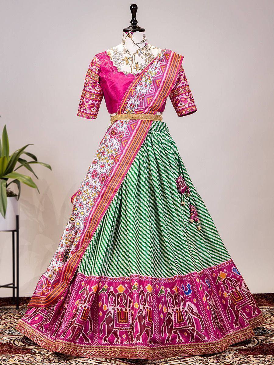 Vibrant pink and green ethnic lehenga choli with elephant print, perfect for Indian weddings and festivals