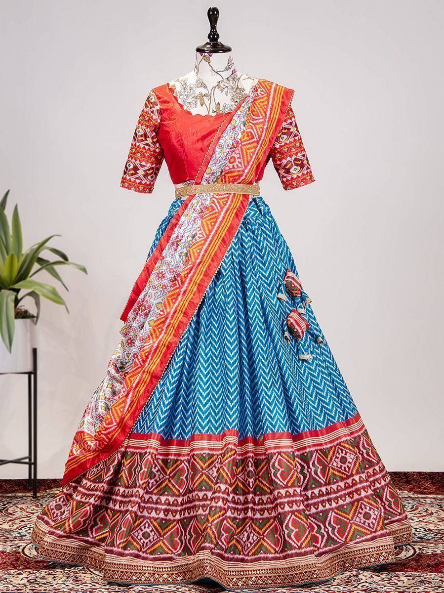 Vibrant red and blue printed lehenga choli with ethnic patterns, perfect for festive occasions