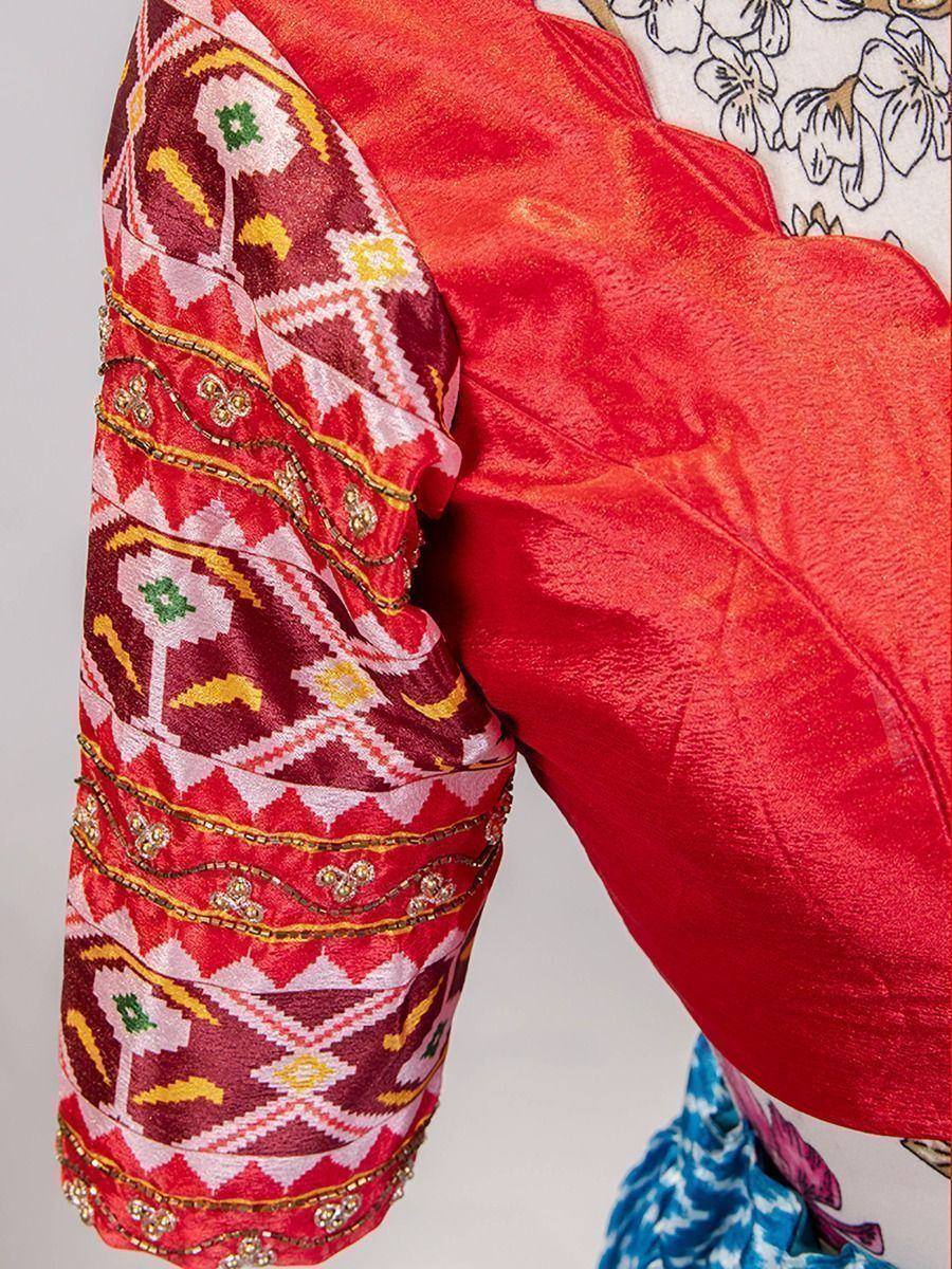 Red ethnic blouse with embroidered geometric sleeve design, perfect for lehenga choli or saree