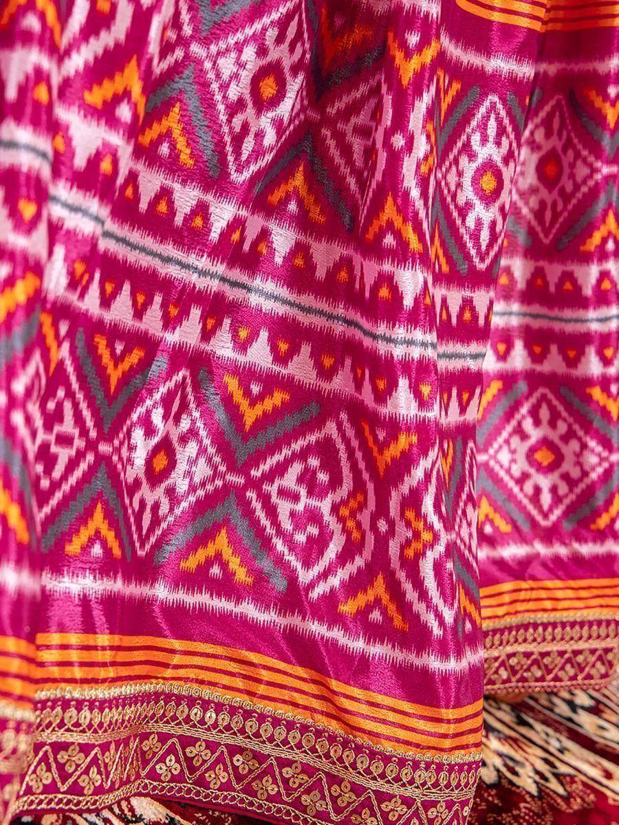 Vibrant pink ethnic dress with geometric ikat print and gold border detailing