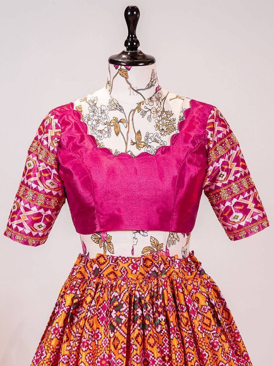 Vibrant pink and orange printed ethnic lehenga choli with floral and geometric patterns, perfect for festive occasions.
