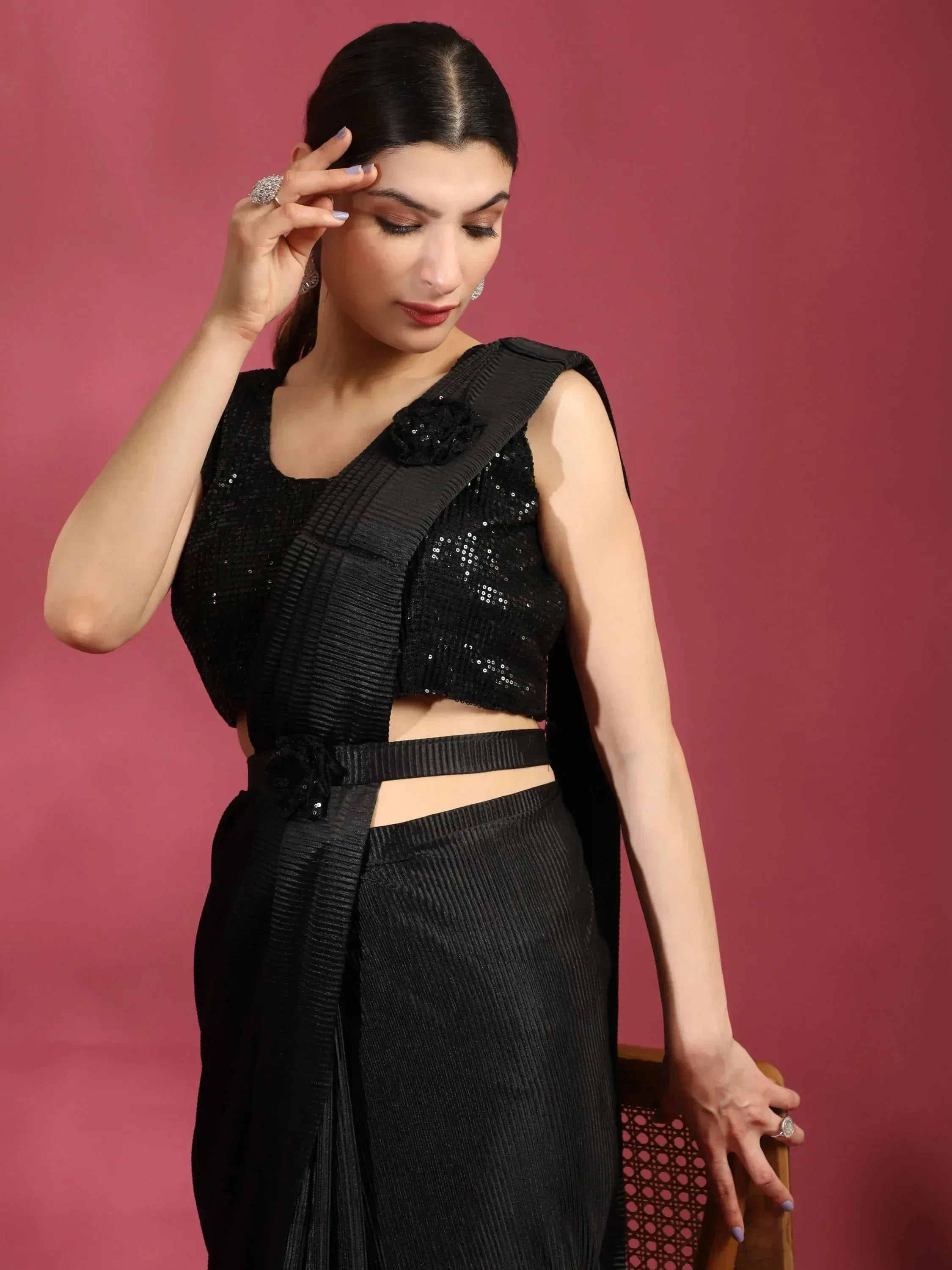 Black sequin and pleated ethnic gown with floral embellishments, perfect for Indian festive occasions.