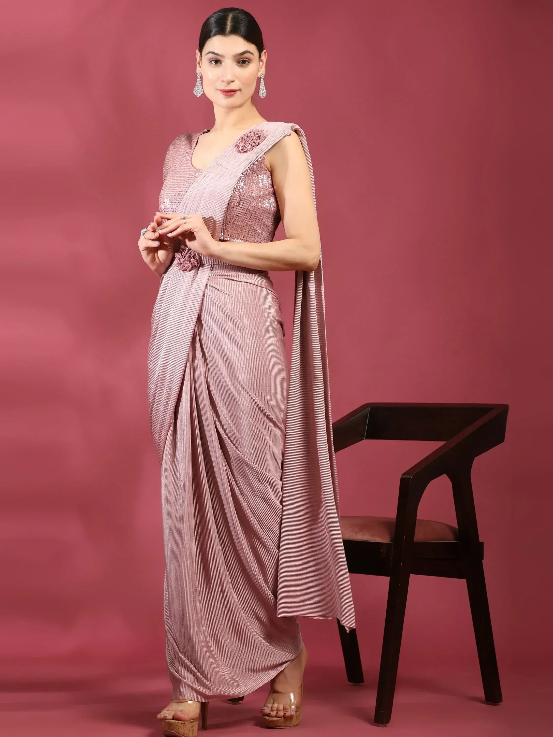 Elegant pink sequined saree with floral embellishments, styled for Indian ethnic wear