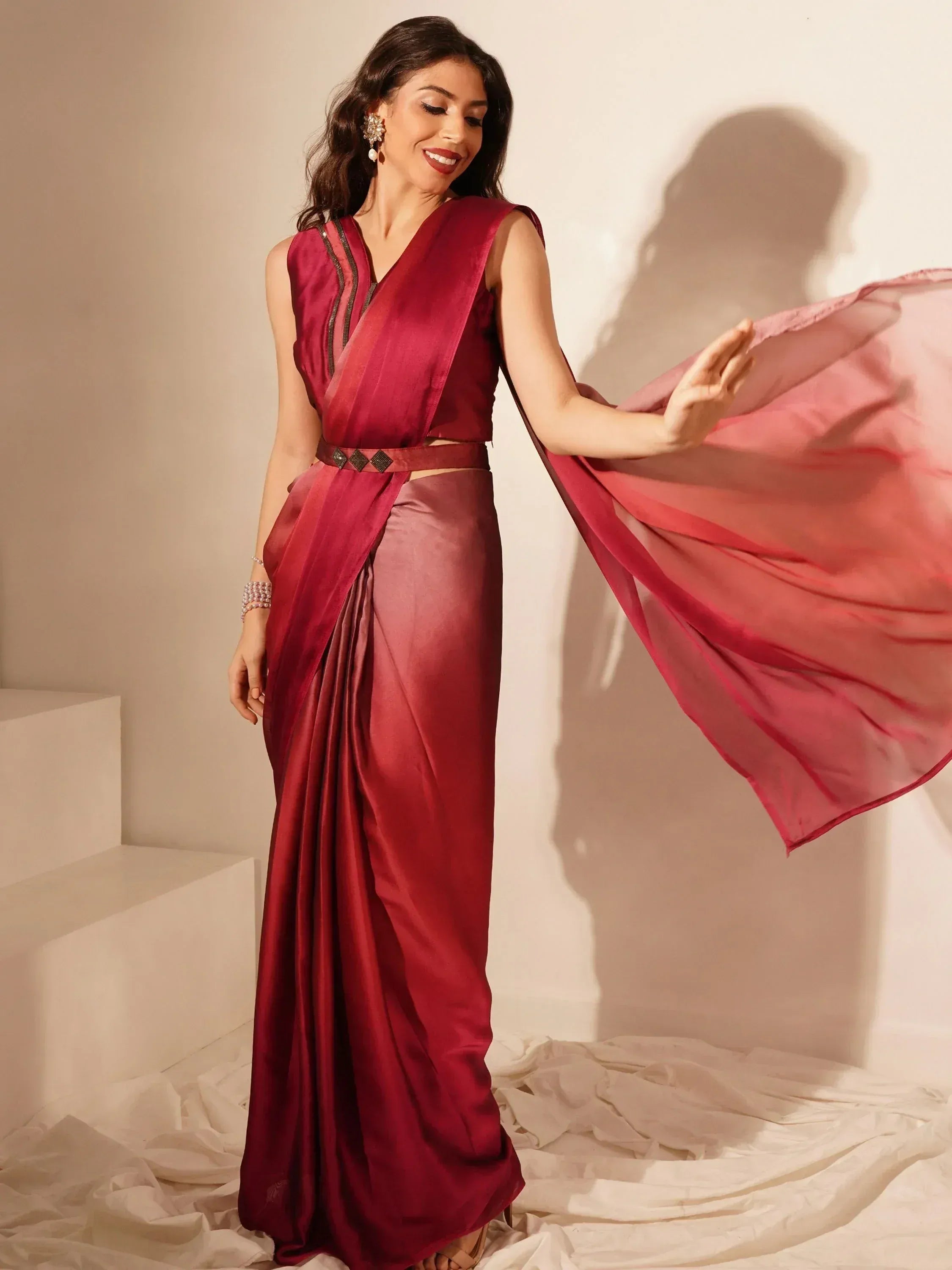 Woman in elegant maroon saree gown with flowing dupatta, perfect for Indian ethnic wear occasions