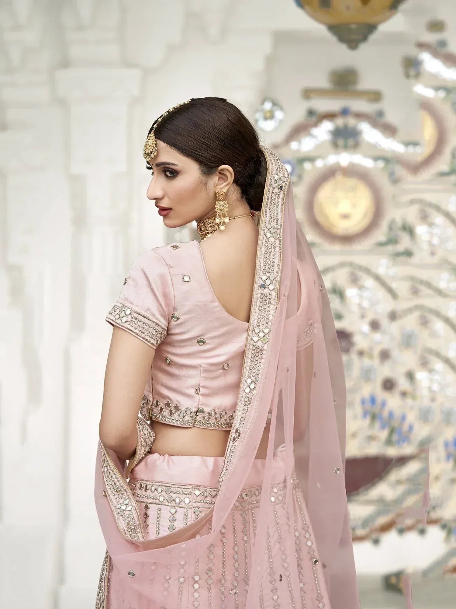 Pink designer lehenga choli with mirror work, perfect for Indian weddings and festive occasions.