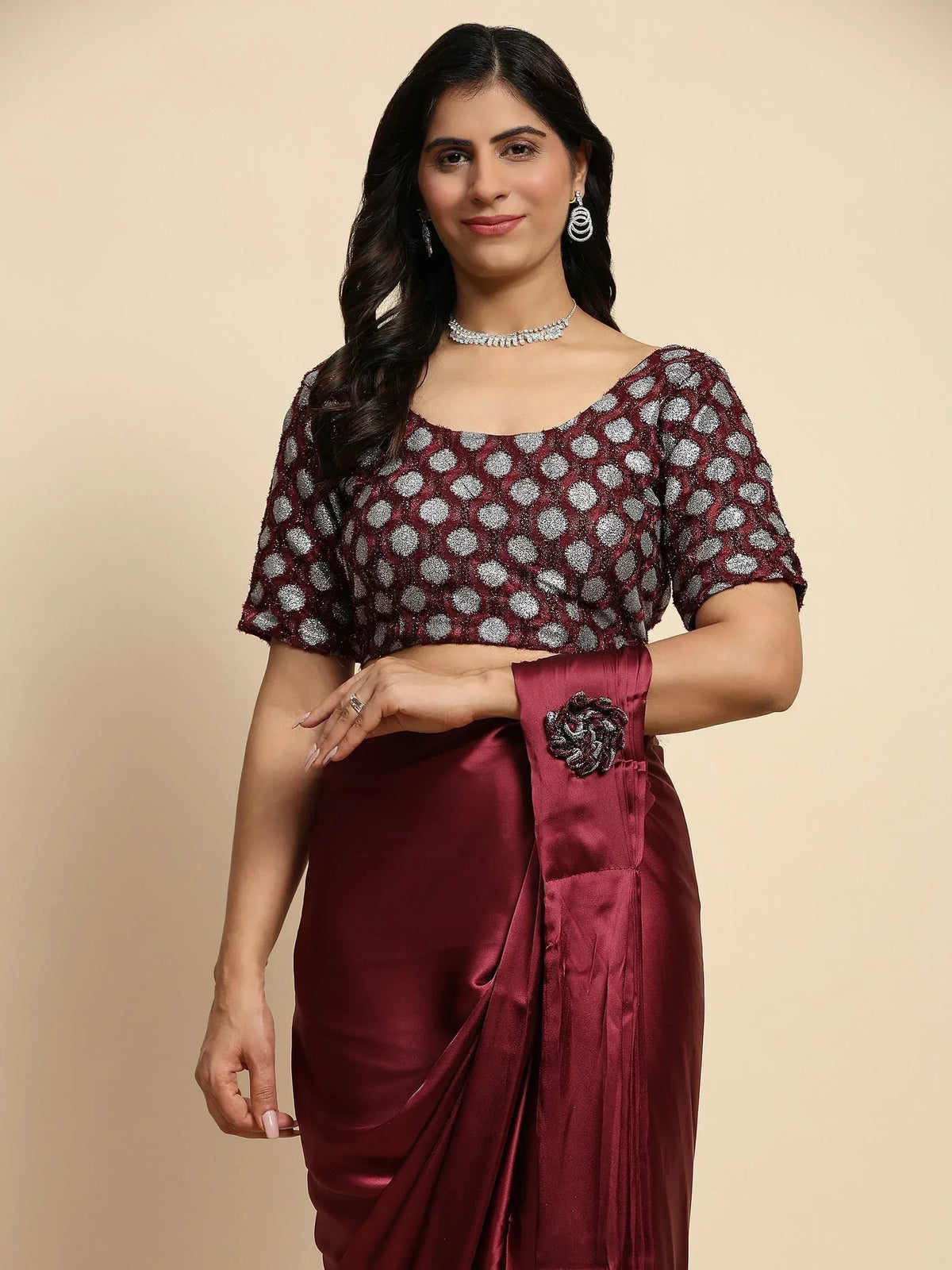 Woman in maroon saree with silver polka dot blouse, elegant ethnic wear for festive occasions