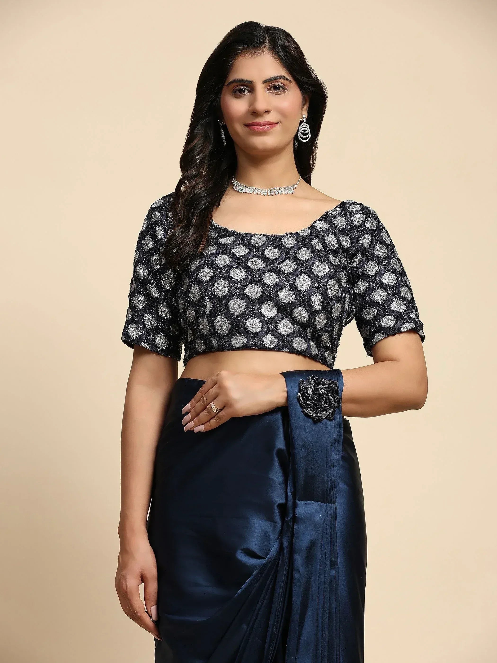 Woman in navy blue saree with polka dot blouse, ethnic Indian wear for festive occasions