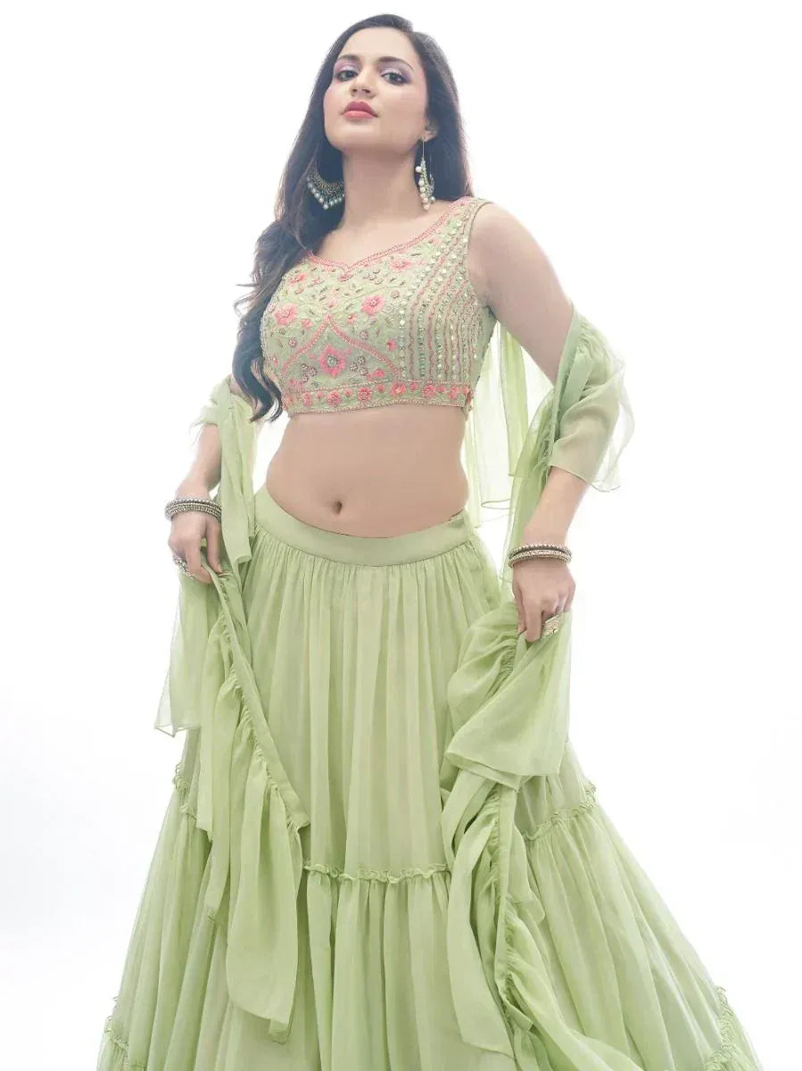 Light green embroidered lehenga choli with floral detailing and ruffled skirt, perfect for Indian ethnic wear