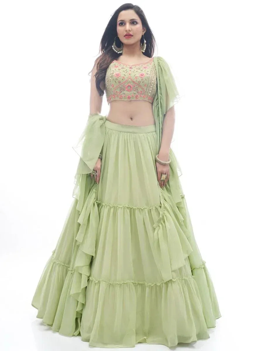 Light green designer lehenga choli with floral embroidery and ruffled skirt, perfect for Indian ethnic wear