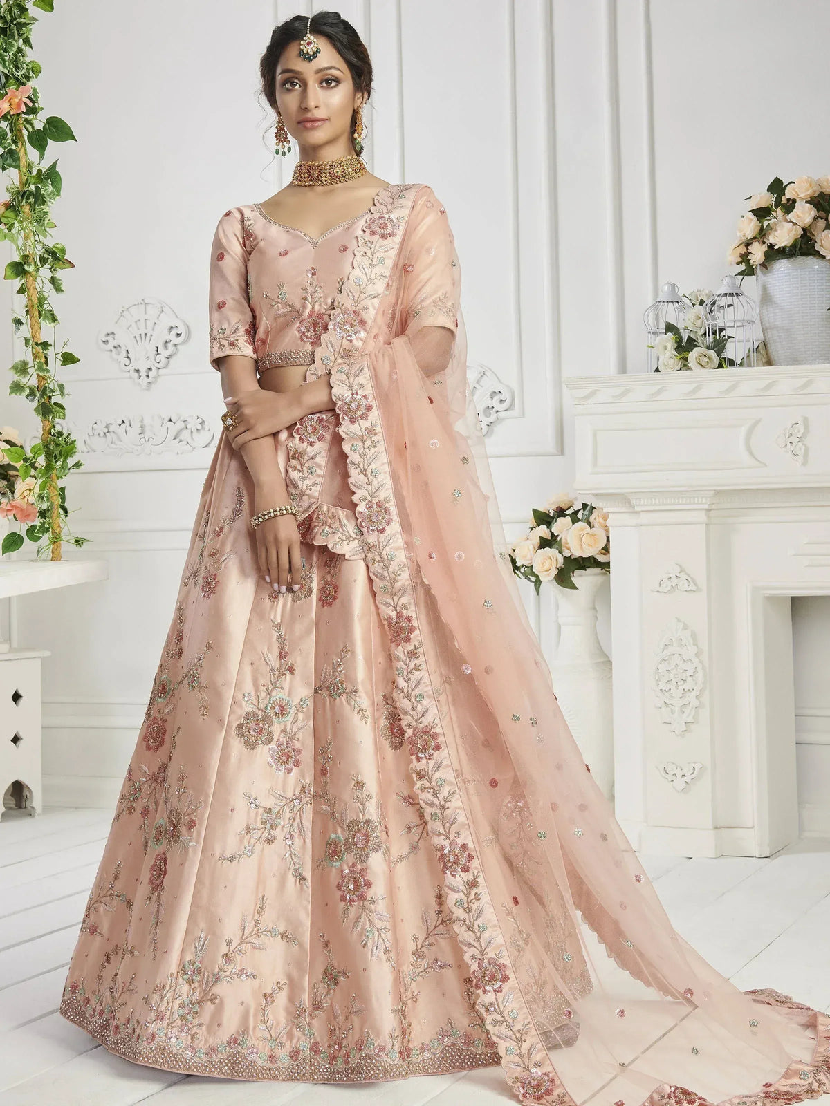 Pink embroidered lehenga choli with floral motifs, perfect for Indian weddings and festive occasions.