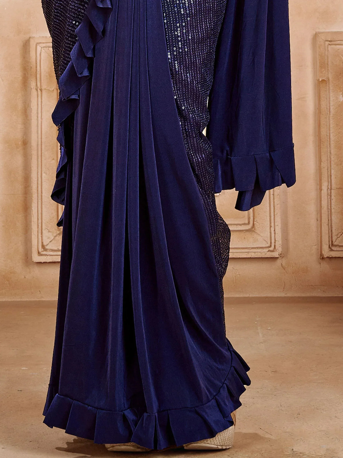 Navy blue ethnic gown with ruffles and sequin detailing, perfect for festive occasions