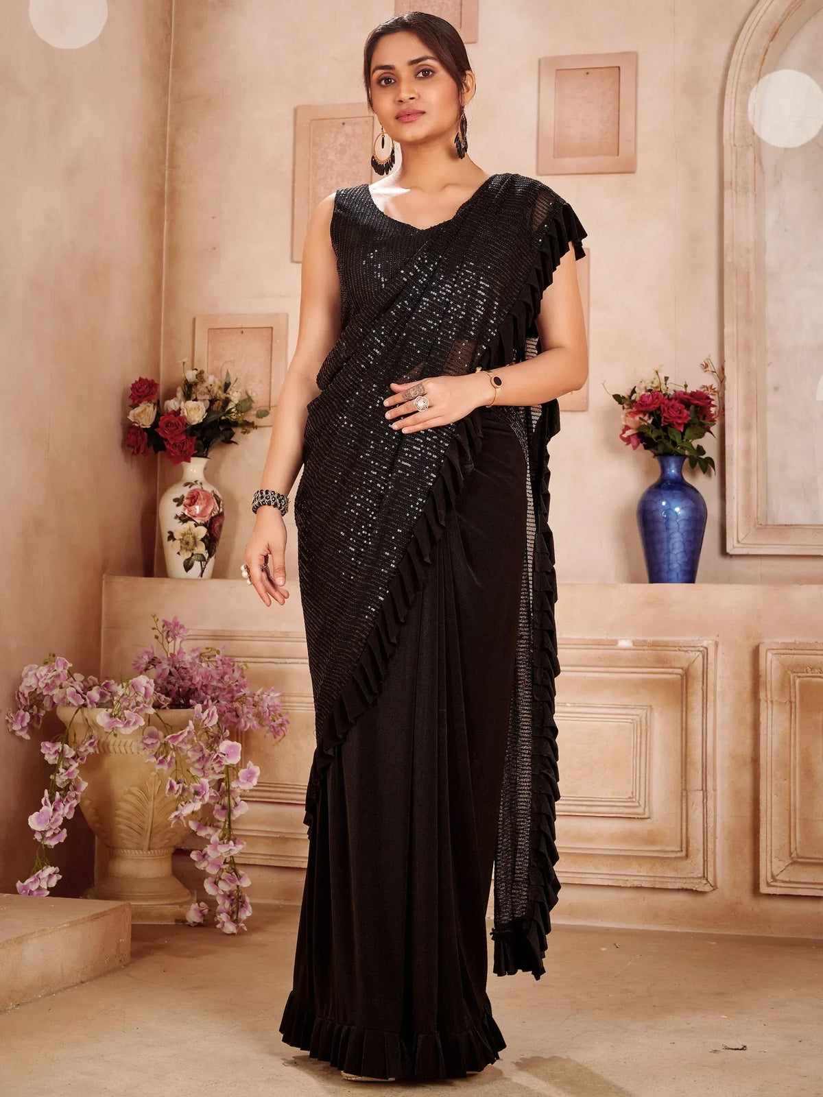 Black sequin saree with ruffle detailing, perfect for ethnic occasions and festive wear