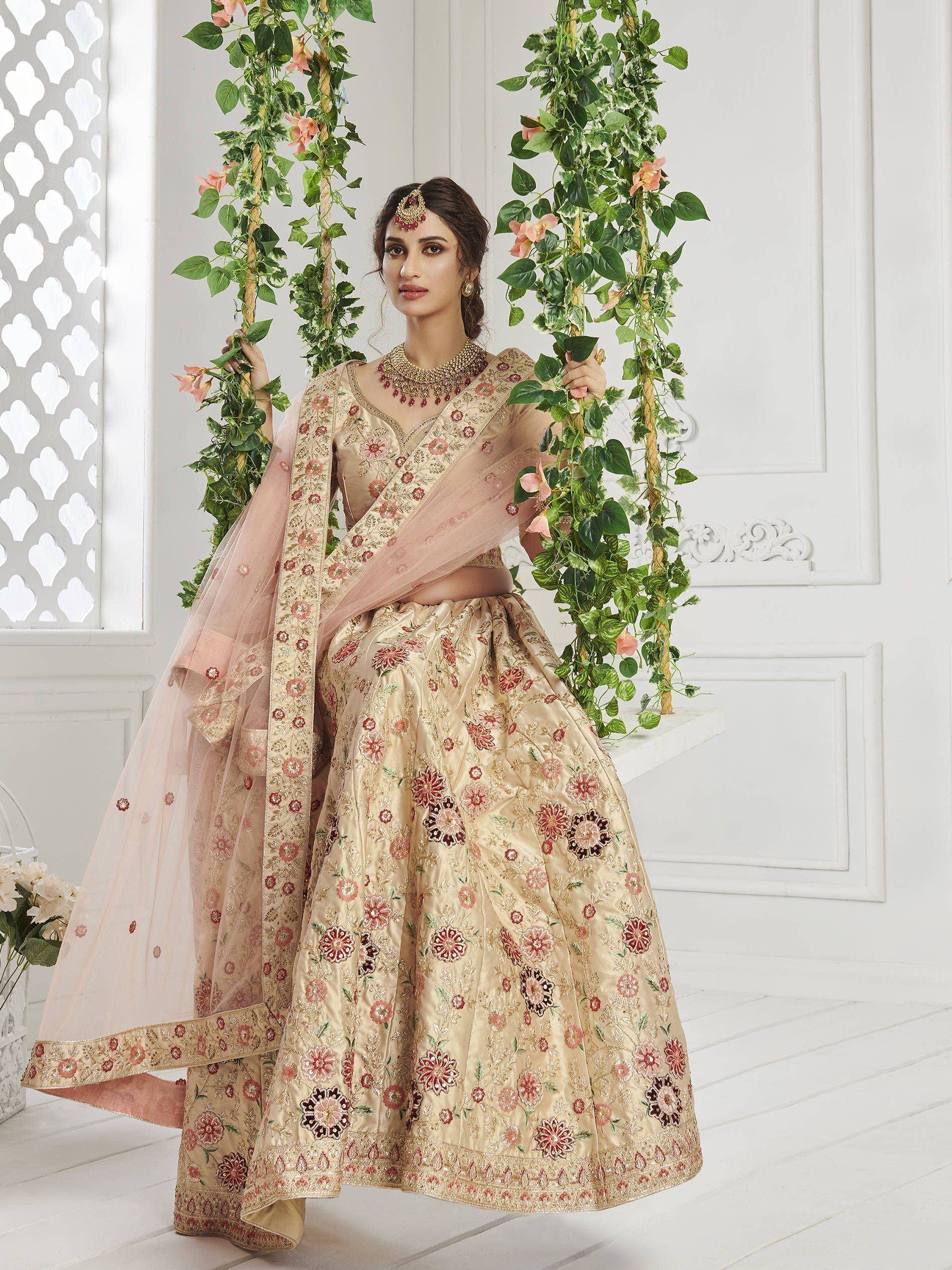 Elegant beige floral embroidered lehenga choli with pink dupatta, perfect for Indian weddings and festive occasions.