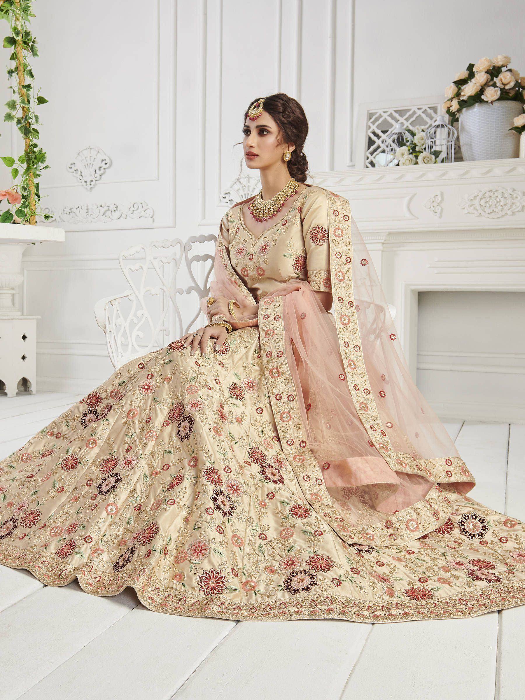 Elegant beige floral embroidered lehenga choli with pink dupatta, perfect for Indian weddings and festive occasions.