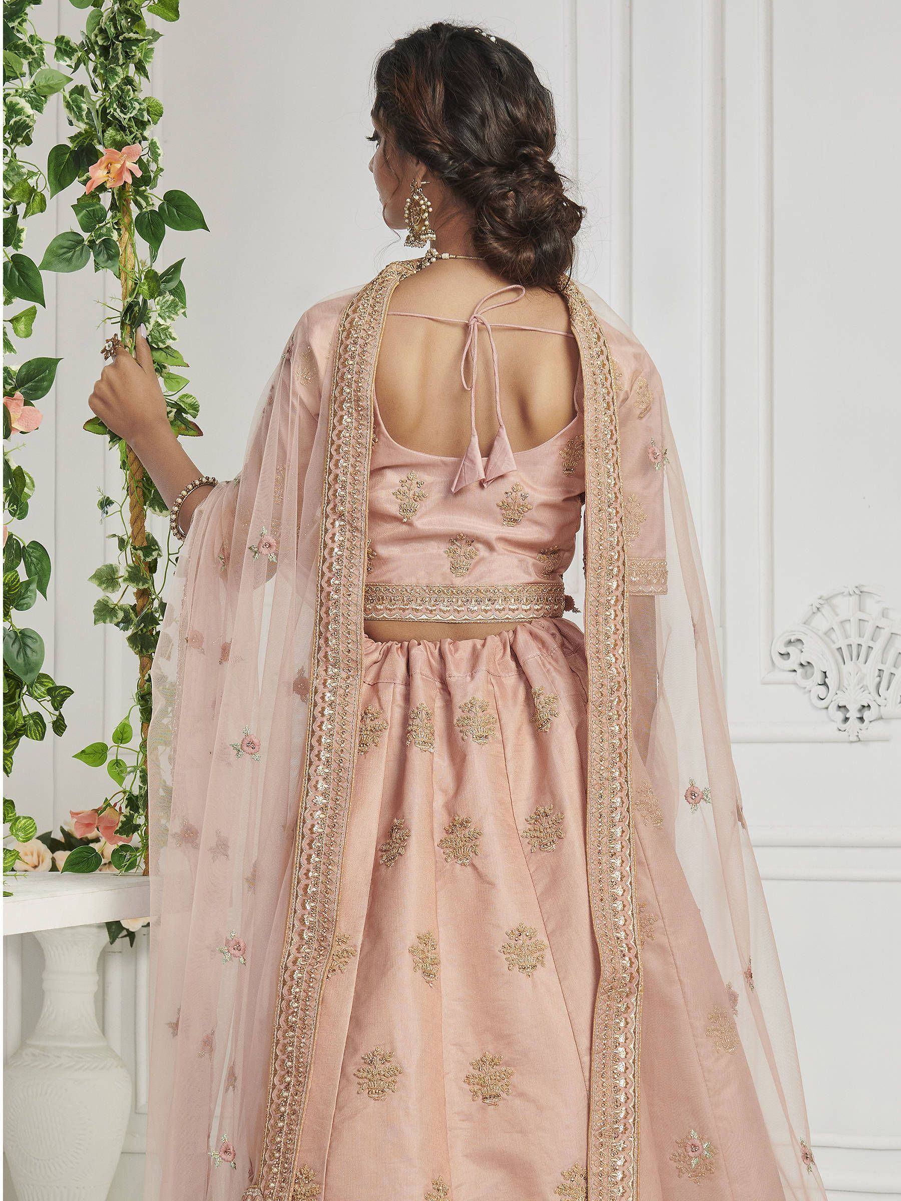 Pink embroidered lehenga choli with gold detailing and sheer dupatta, back view