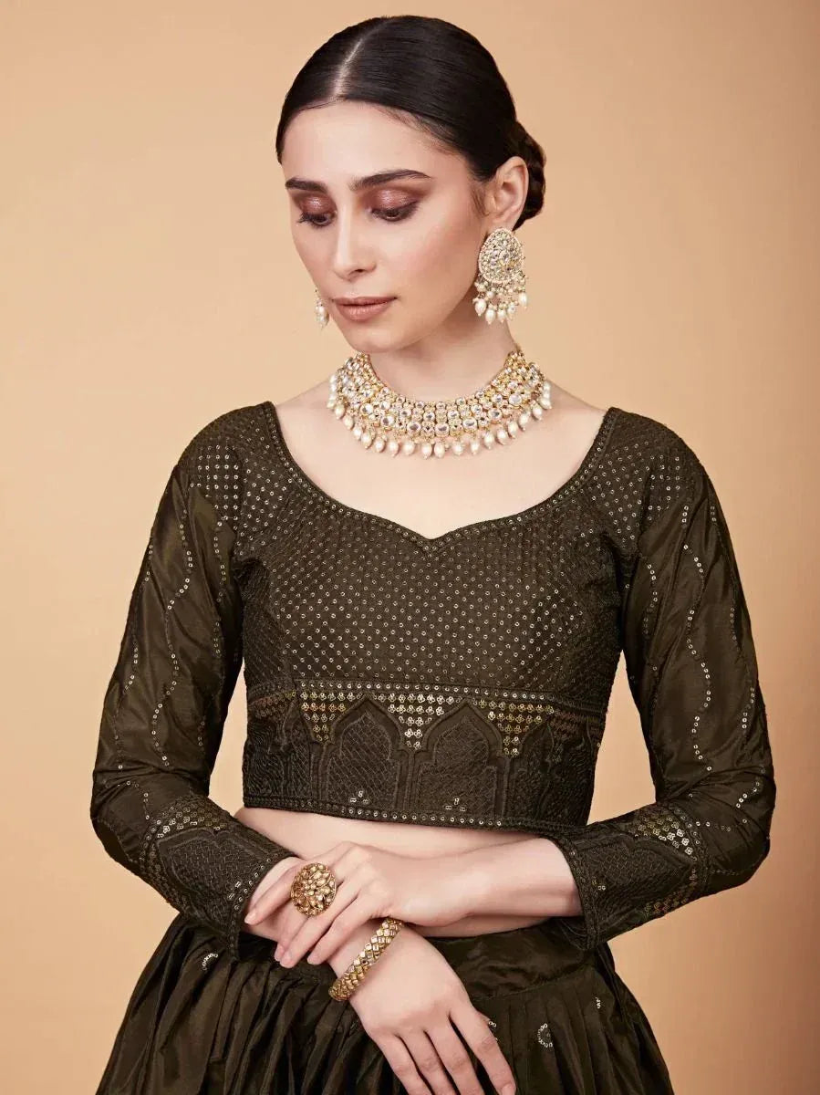 Olive green embroidered crop top with matching skirt, traditional Indian ethnic wear, adorned with pearl jewelry