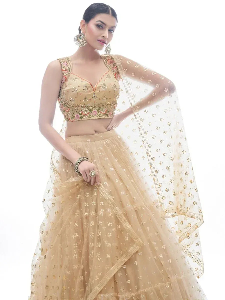 Beige embroidered lehenga choli with floral motifs and sheer dupatta, perfect for Indian ethnic occasions