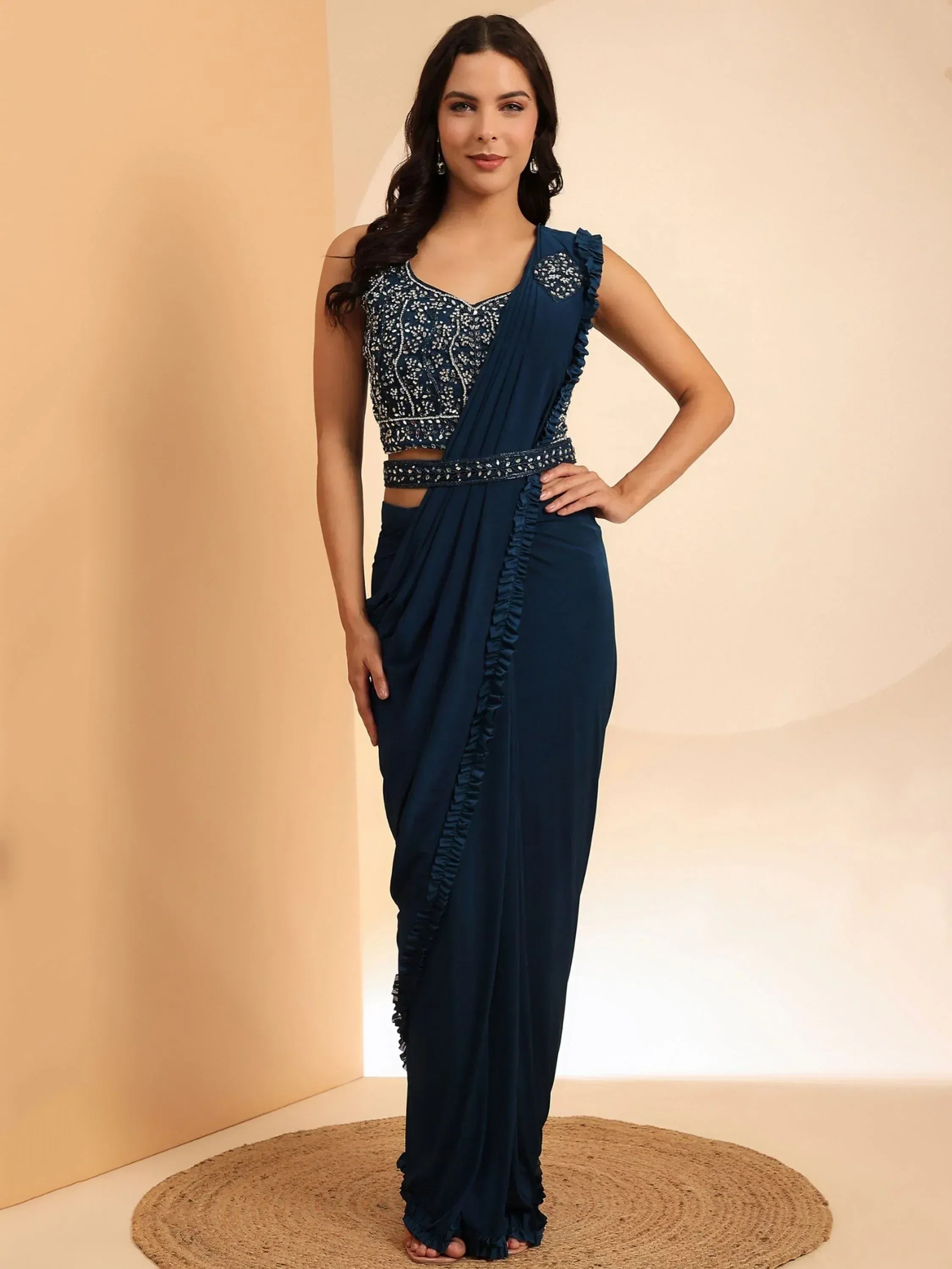 Navy blue designer saree with ruffle detailing and embroidered blouse, perfect for ethnic occasions