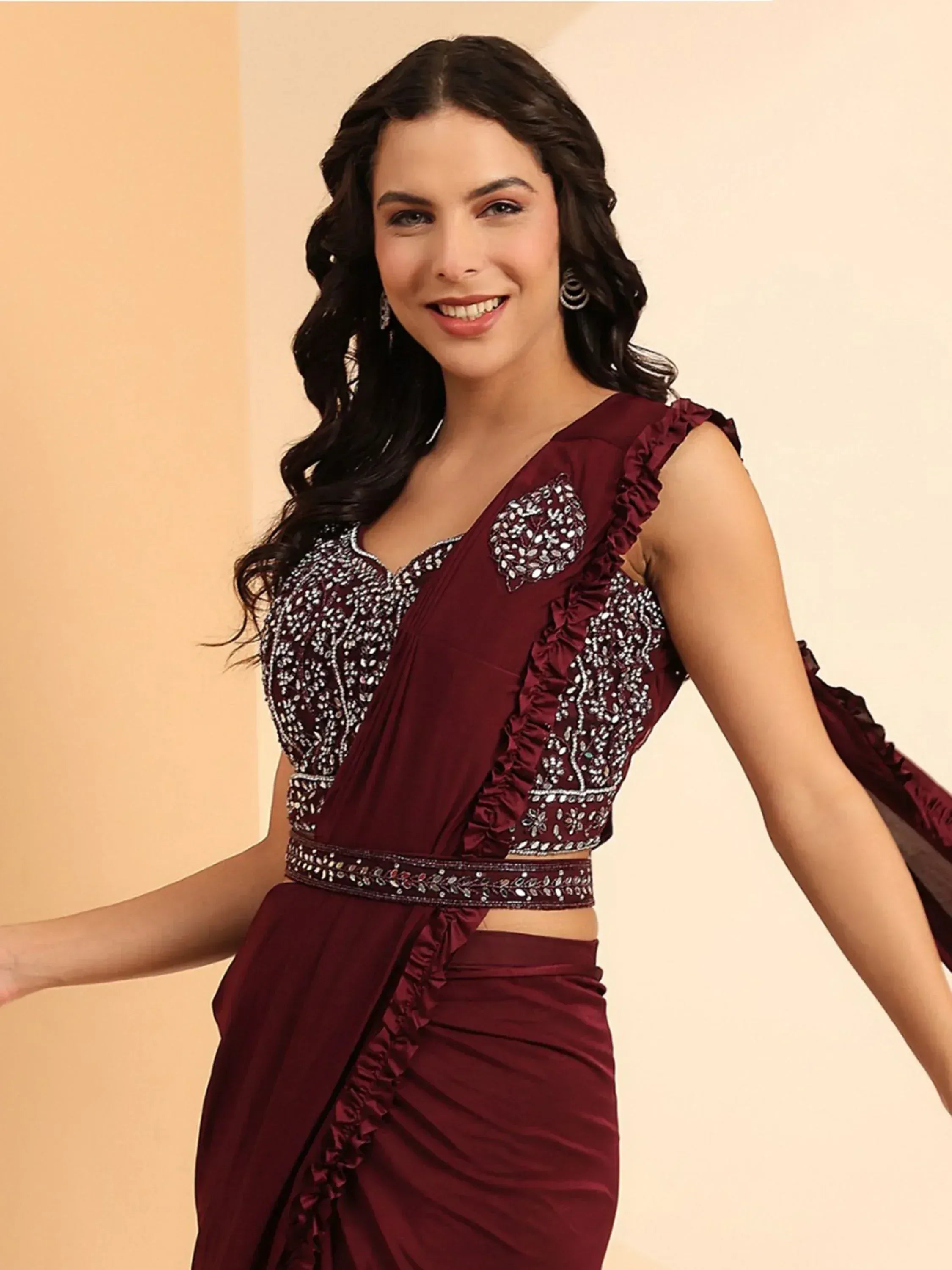 Maroon ethnic gown with ruffles and silver embroidery, perfect for Indian occasions