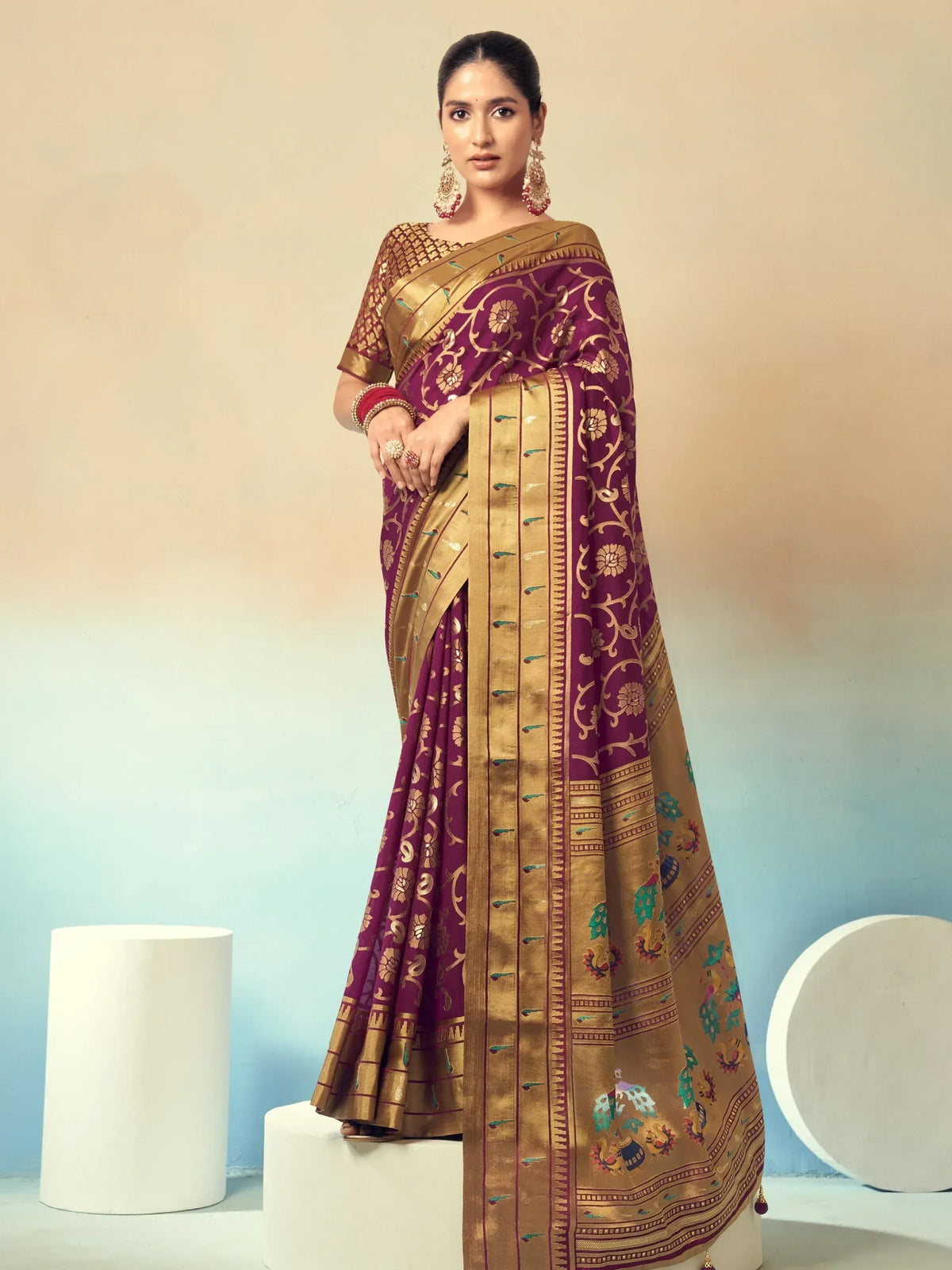 Elegant purple and gold designer saree with intricate floral zari work, perfect for Indian ethnic occasions